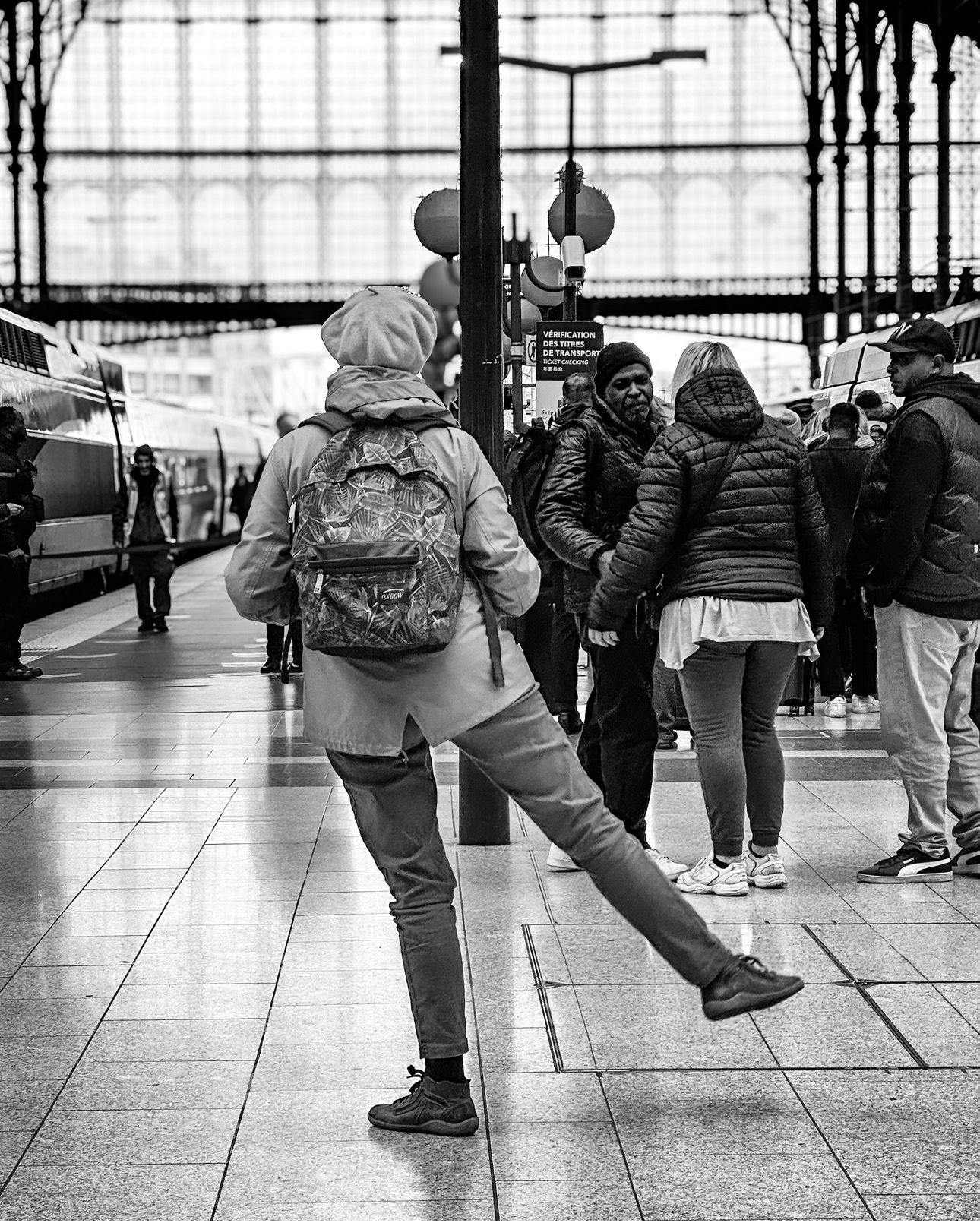 Paris Notre Dame de La Garde station. A lady exercises while waiting for her train.