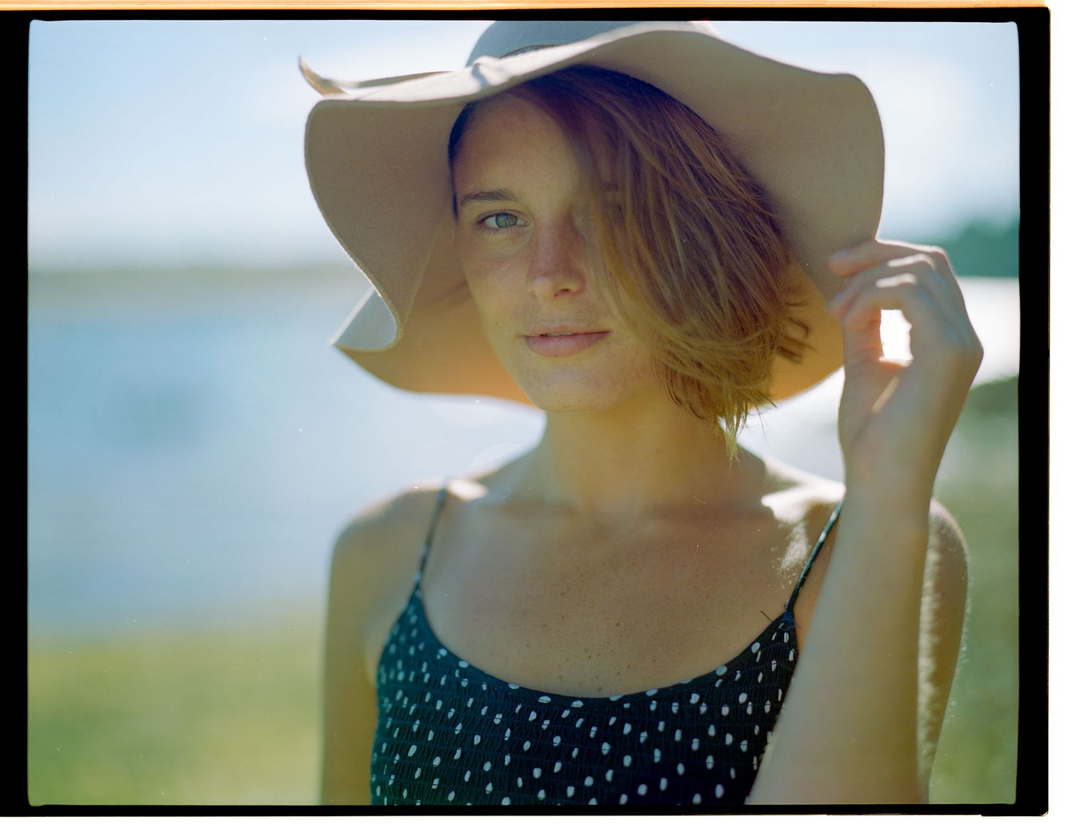 Elegant portrait of a woman with a calm, serious expression outside on a beach — subversePhoto, Cork.