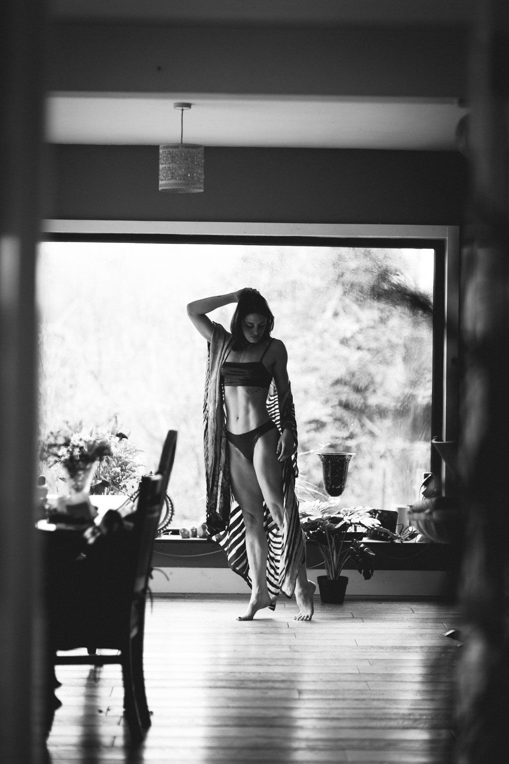 Black and white Female body photography celebrating strength, form, and physical artistry.