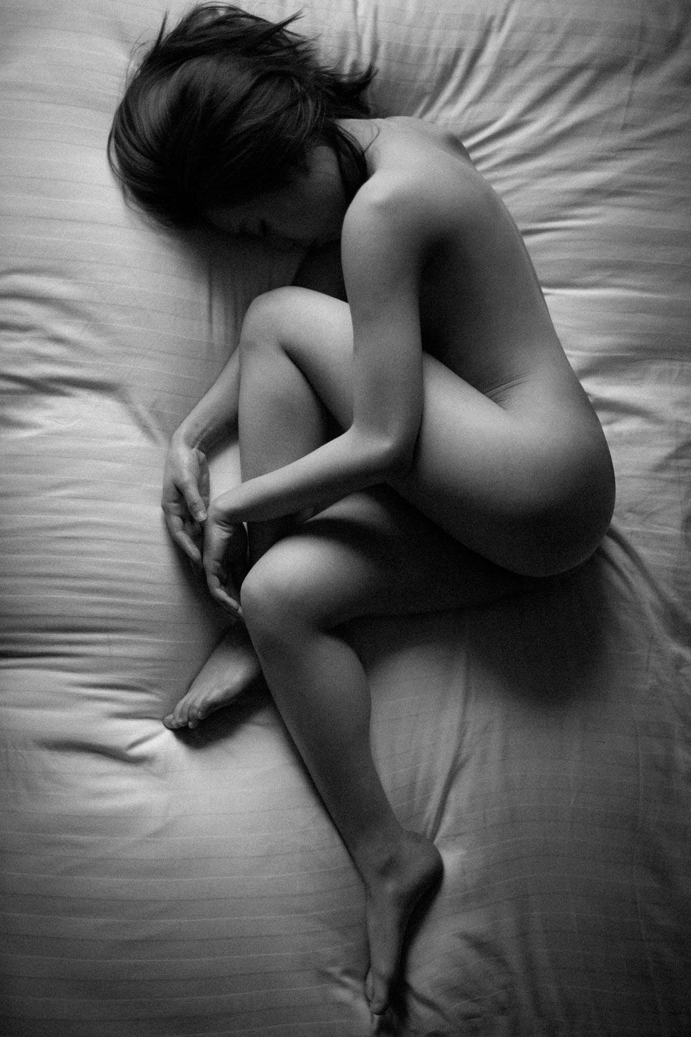 Artistic body composition of female with soft gradients of light and shadow taken by subversephoto