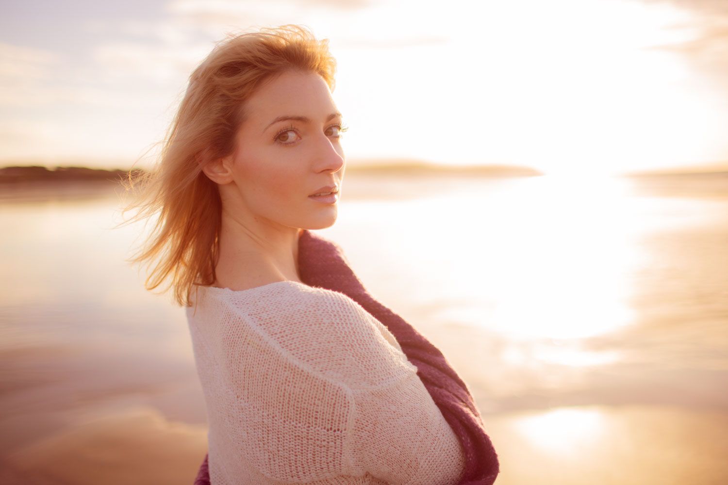 Portrait of a woman with direct gaze, photographed with natural sunrise lighting in Cork.