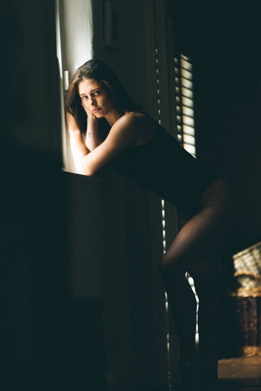 beautiful intimate portrait of a woman with soft lighting highlighting natural form and expression.