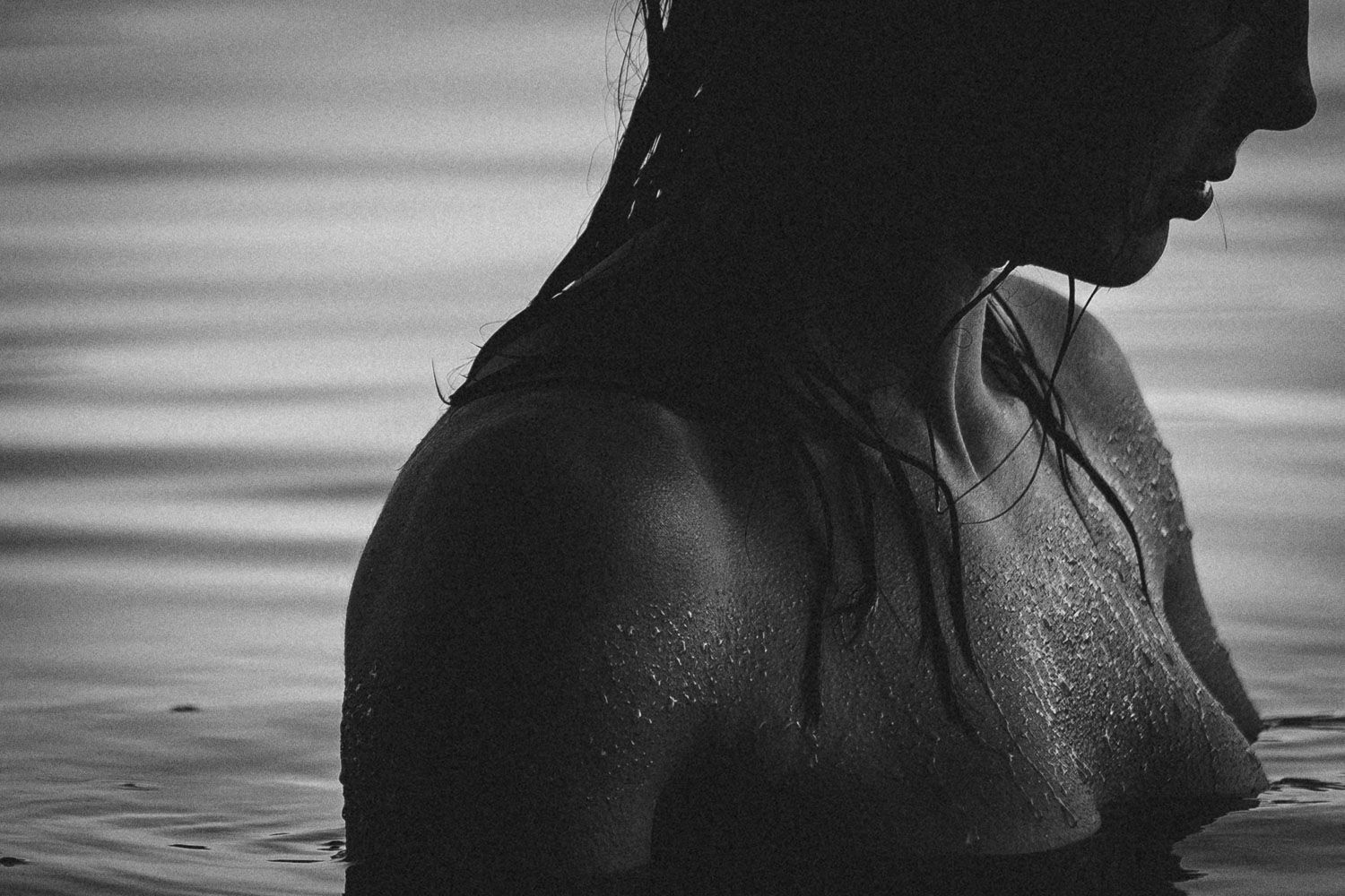Art photograph highlighting skin and water texture and organic shapes with face profile