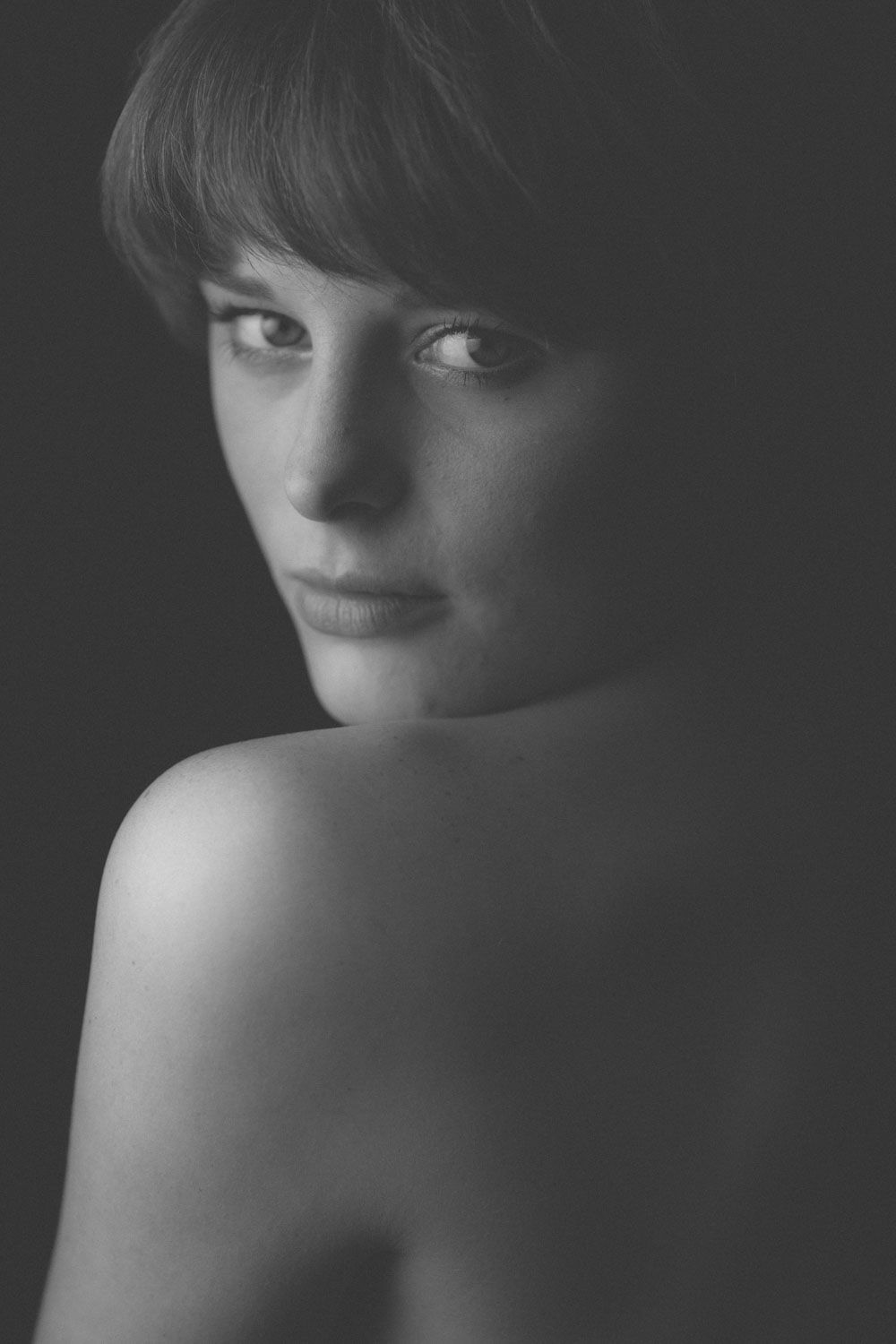 Black and white portrait of a woman gazing into the camera, fine art photography in Ireland.