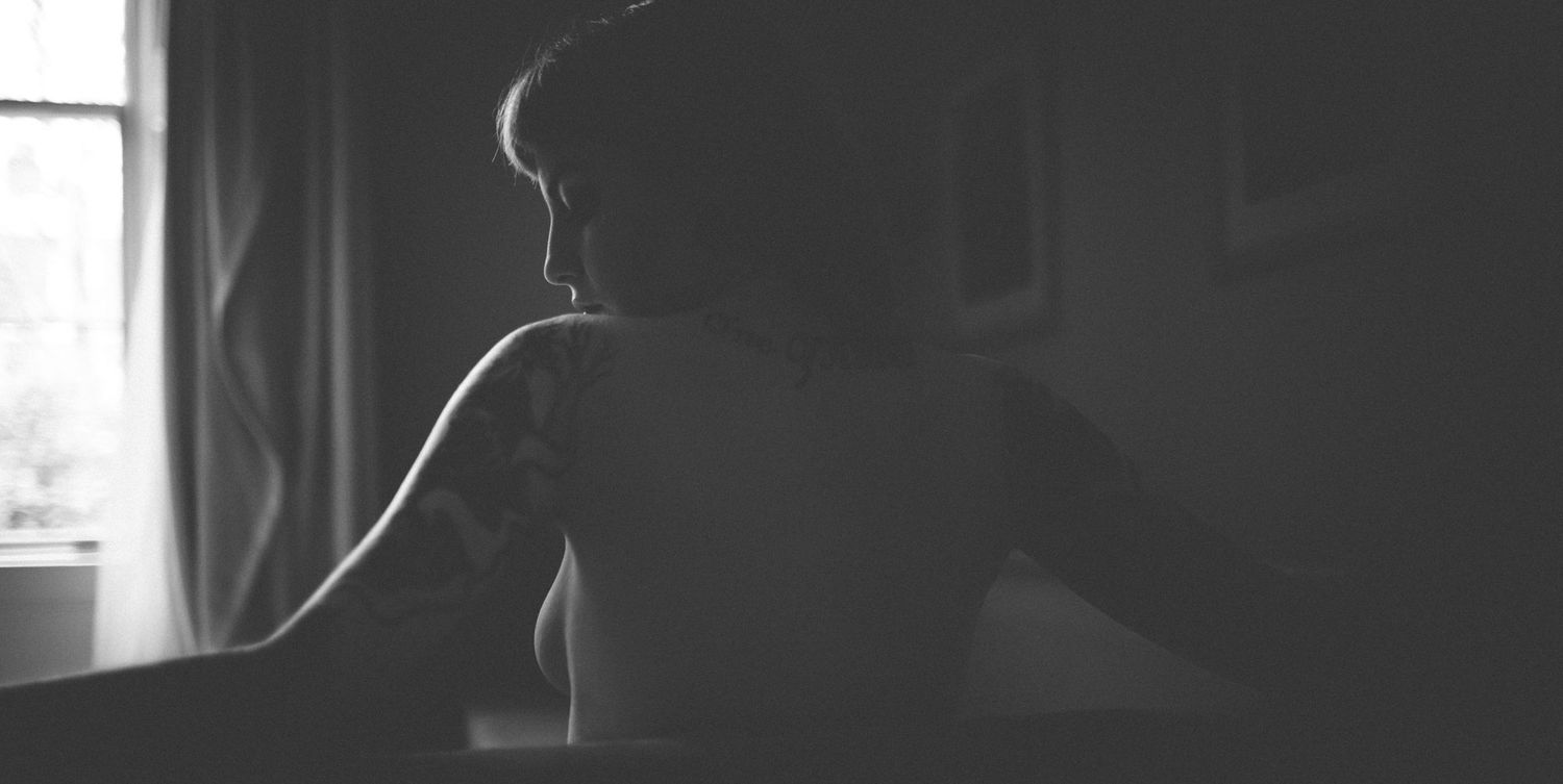 Black and white intimate portrait capturing confidence and elegance.