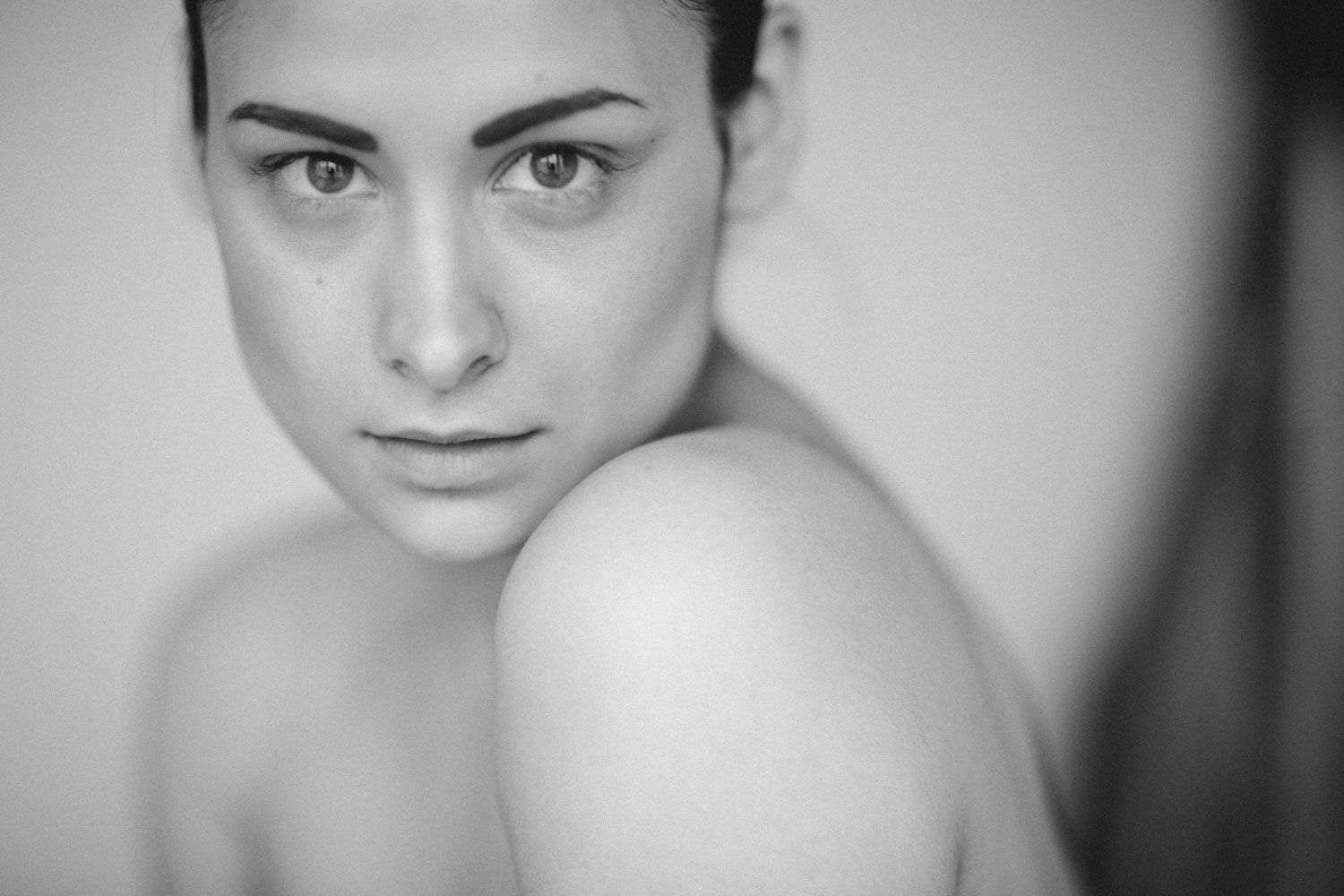 Beautiful professional Black and white portrait of a woman gazing into the camera, fine art photography in Ireland.