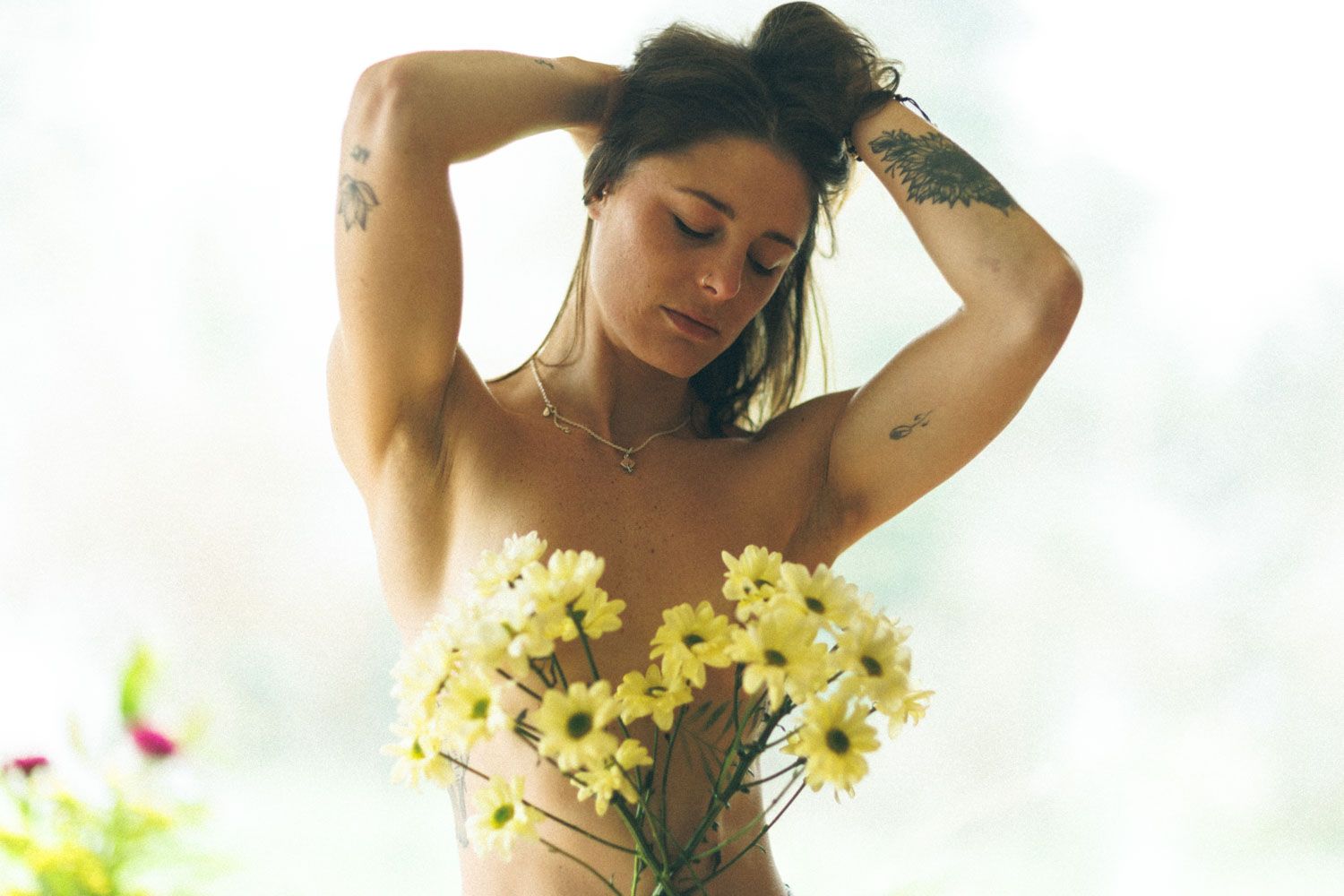 Artistic photograph of a fit woman showing definition in natural light.