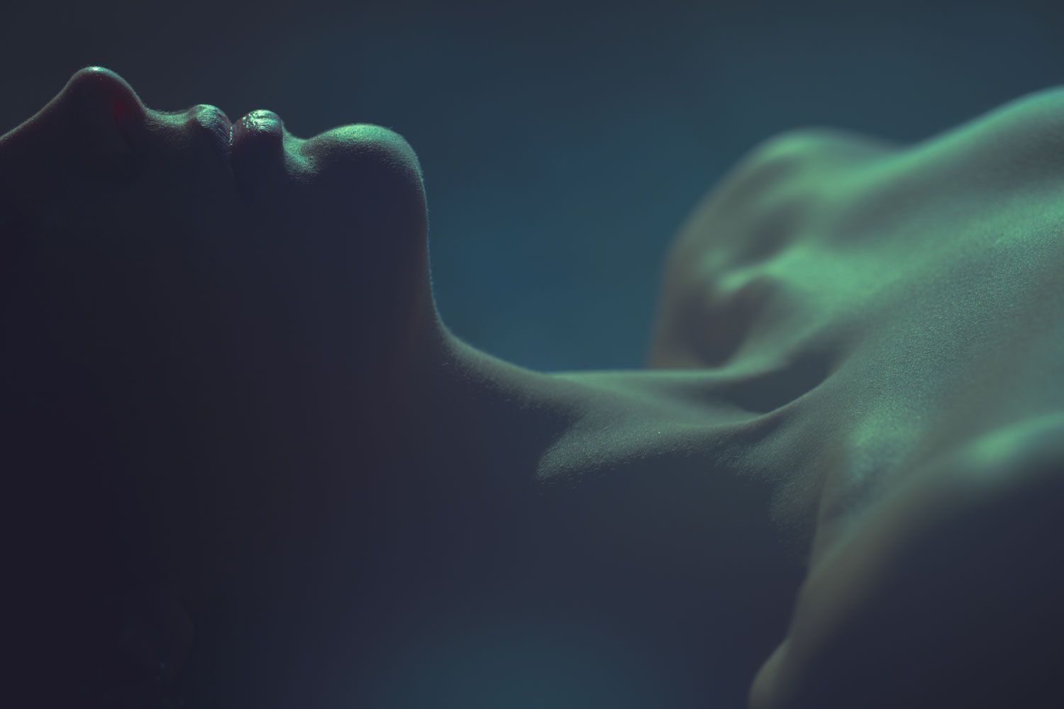 Minimalist body study with dramatic lighting emphasizing texture and shape.