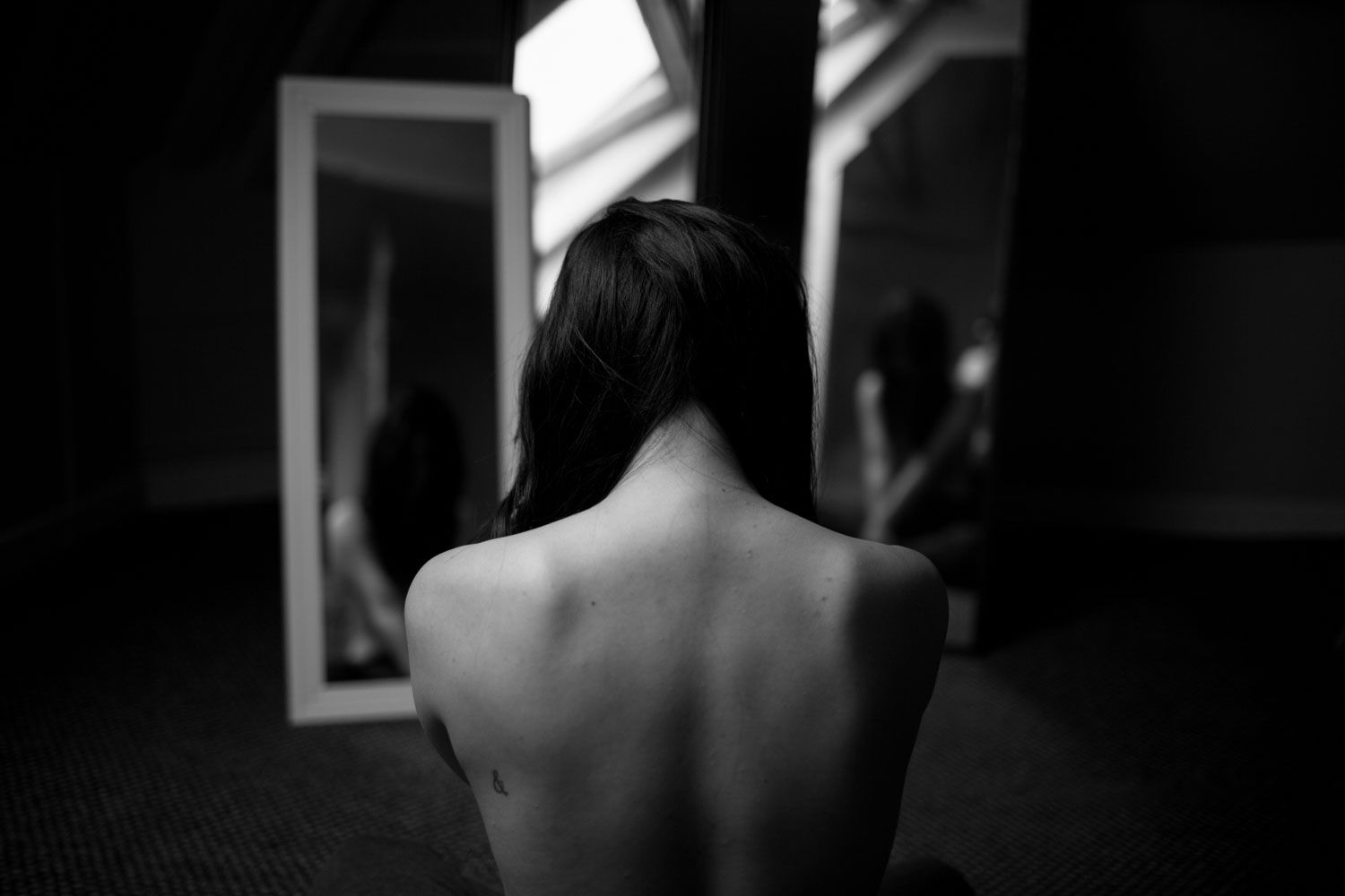 Elegant Black and white body study using reflections to create an abstract composition.