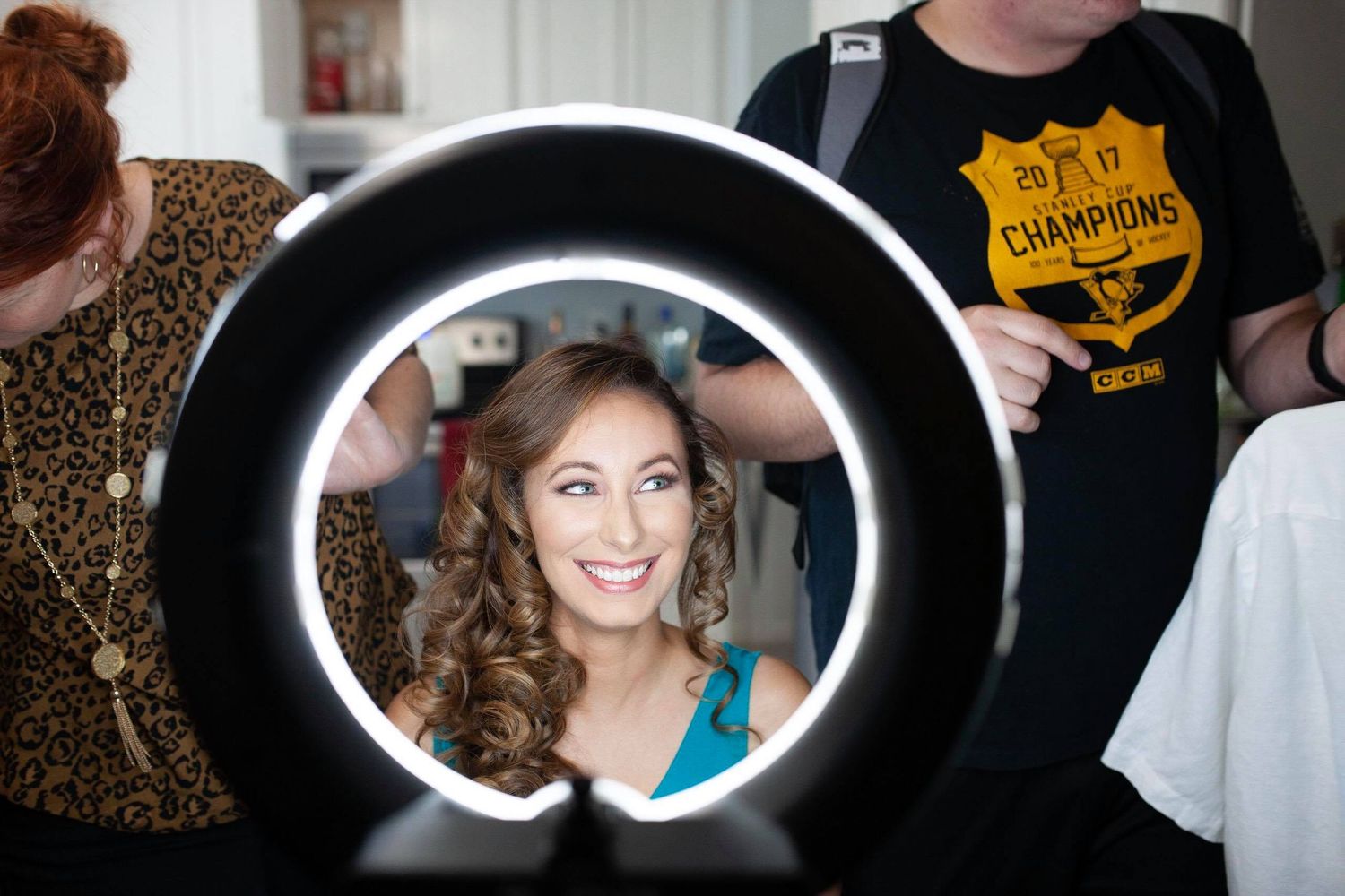 Behind-the-scenes photography session with ring light and professional equipment.