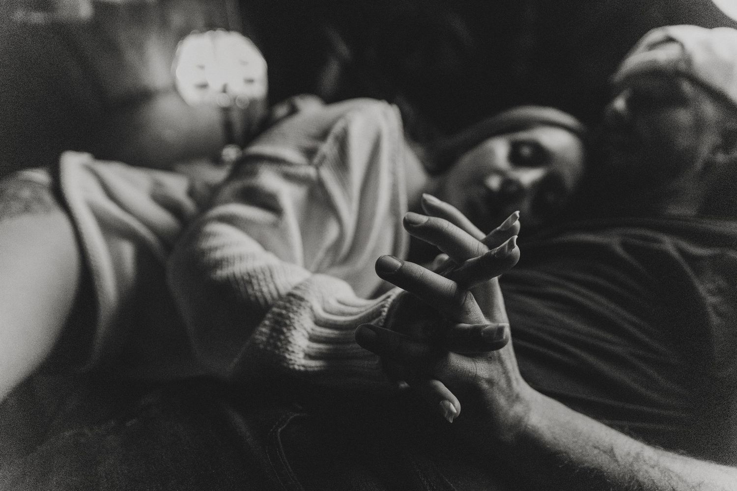 A black and white photo series showing someone sleeping peacefully in bed with dramatic lighting and shadows. Tucson couples boudoir.
