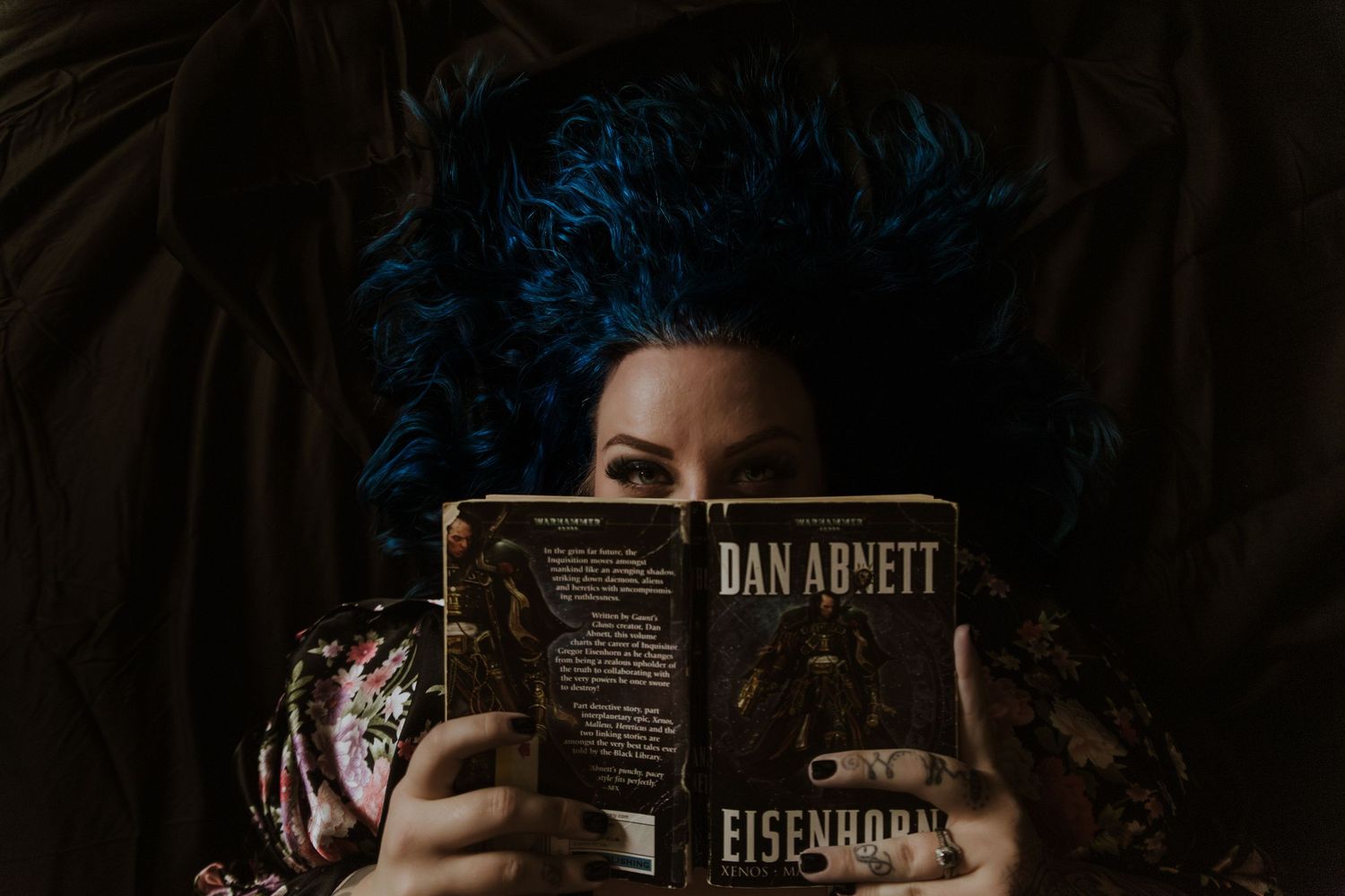 A dark and moody series of photographs showing someone holding a camera in dimly lit conditions. Tucson boudoir.