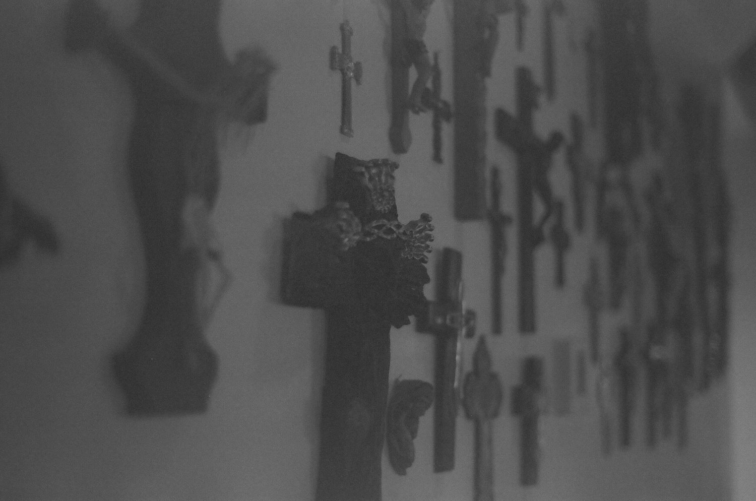 A black and white photograph shows a wall display of various tools and equipment arranged in an organized pattern. Tucson Wedding photograph