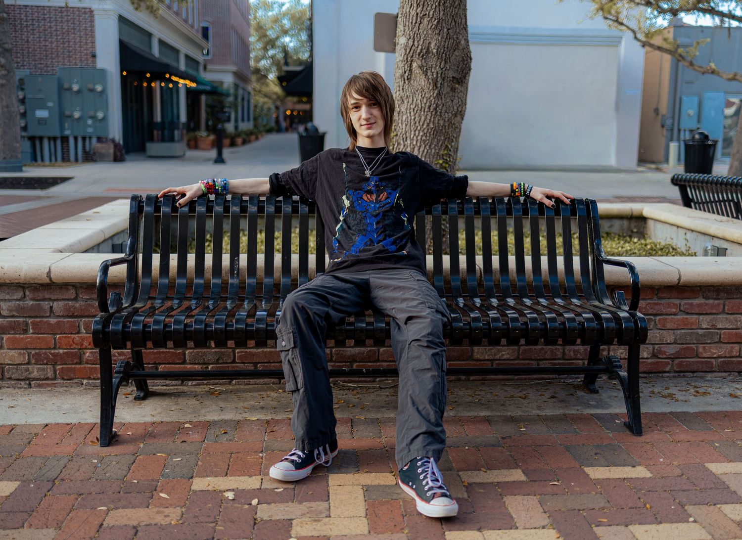 A sequence of photos showing someone performing a parkour-style jump over a bench in an urban setting.