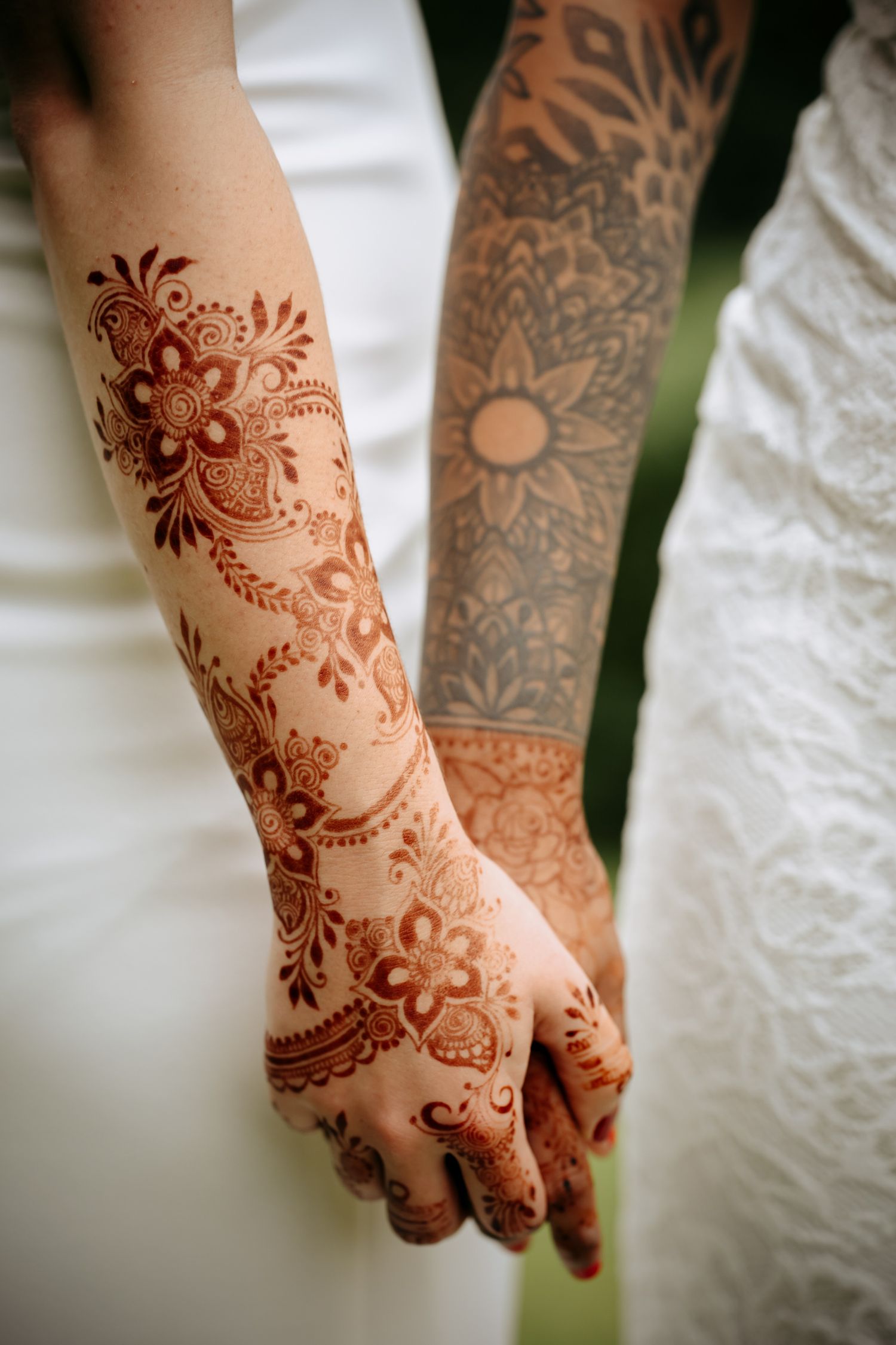 Henna tattoo gay couple holding hands at Marriott Huntingdon wedding.