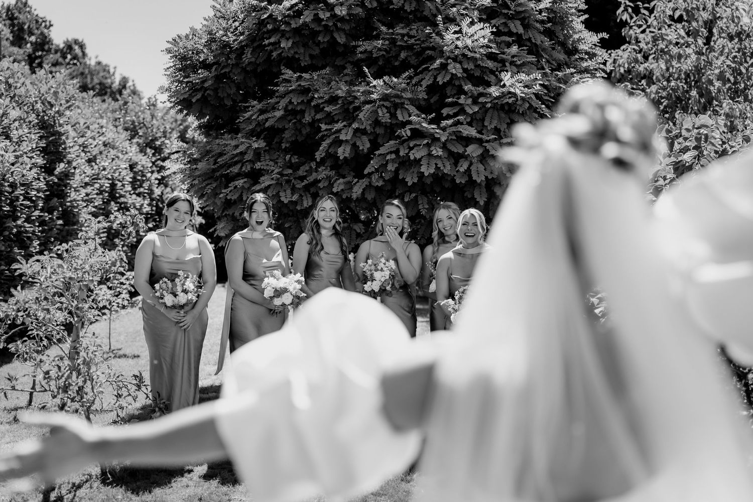 Black and white timeless style first look surprise with bridesmaids.