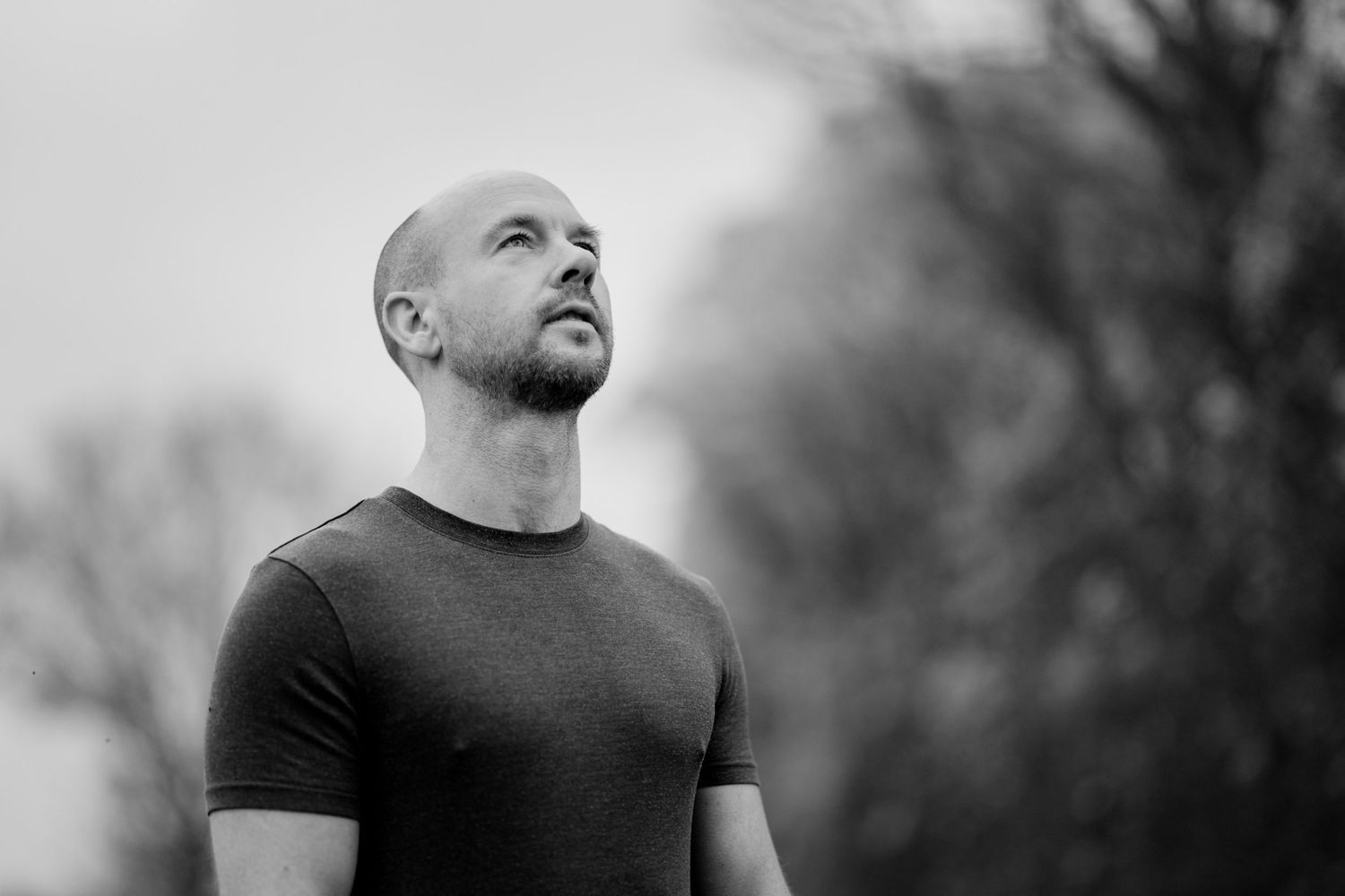 Authentic business portrait photography in St Ives showing a relaxed man in a dark t-shirt.