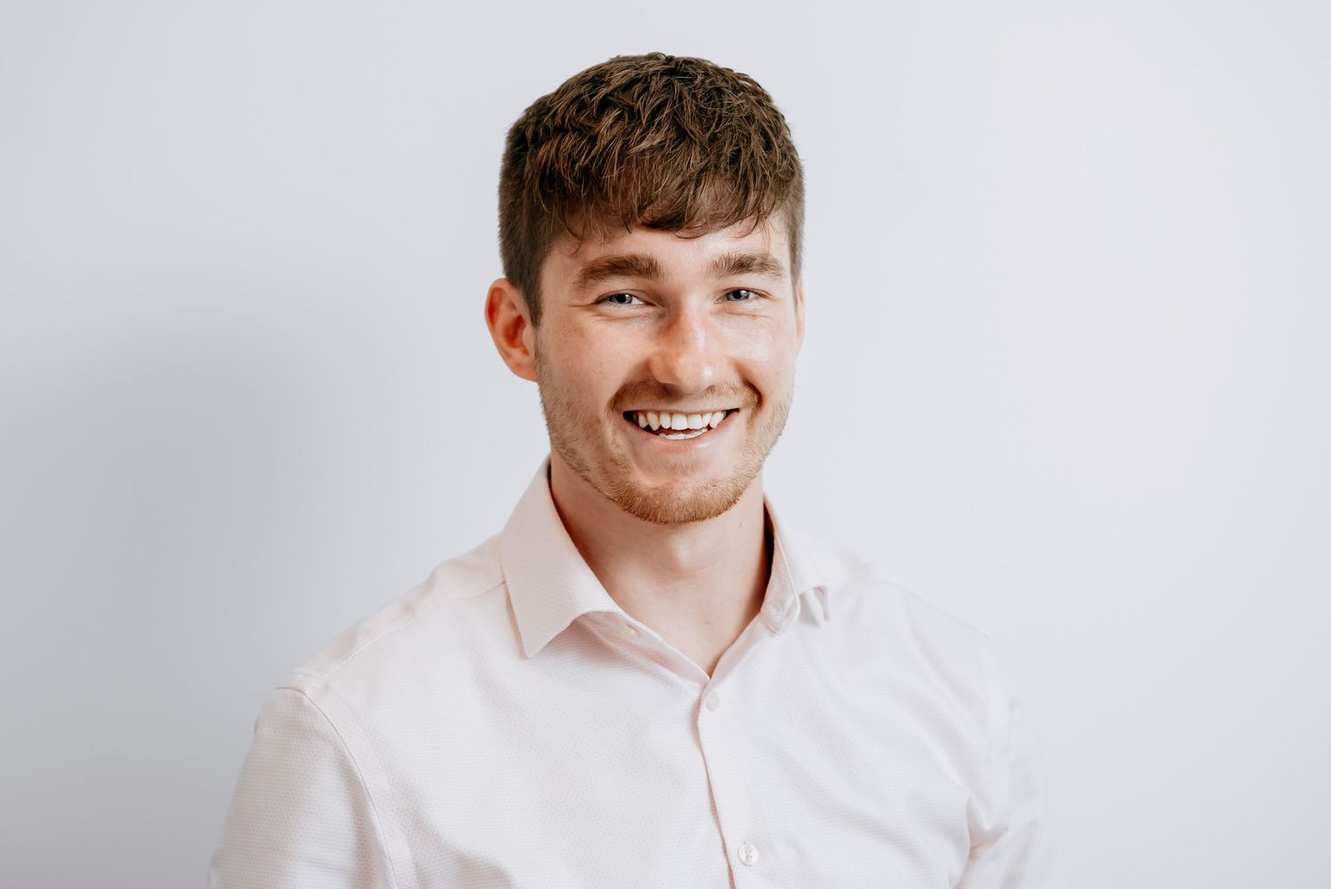Friendly and approachable staff headshot for a Cambridge business team.