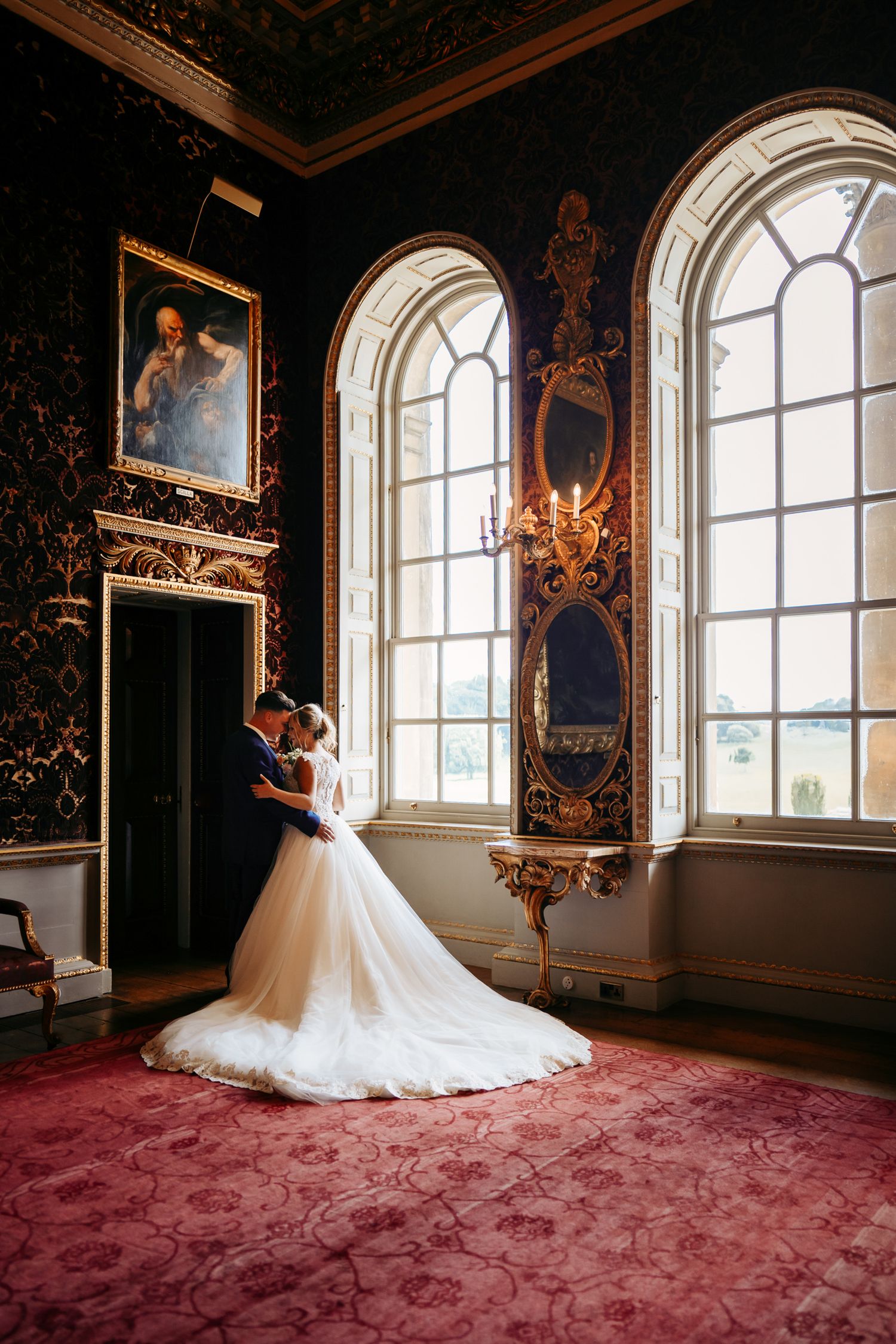 Couple in a hall with a large glass window, Norfolk coast wedding photo.