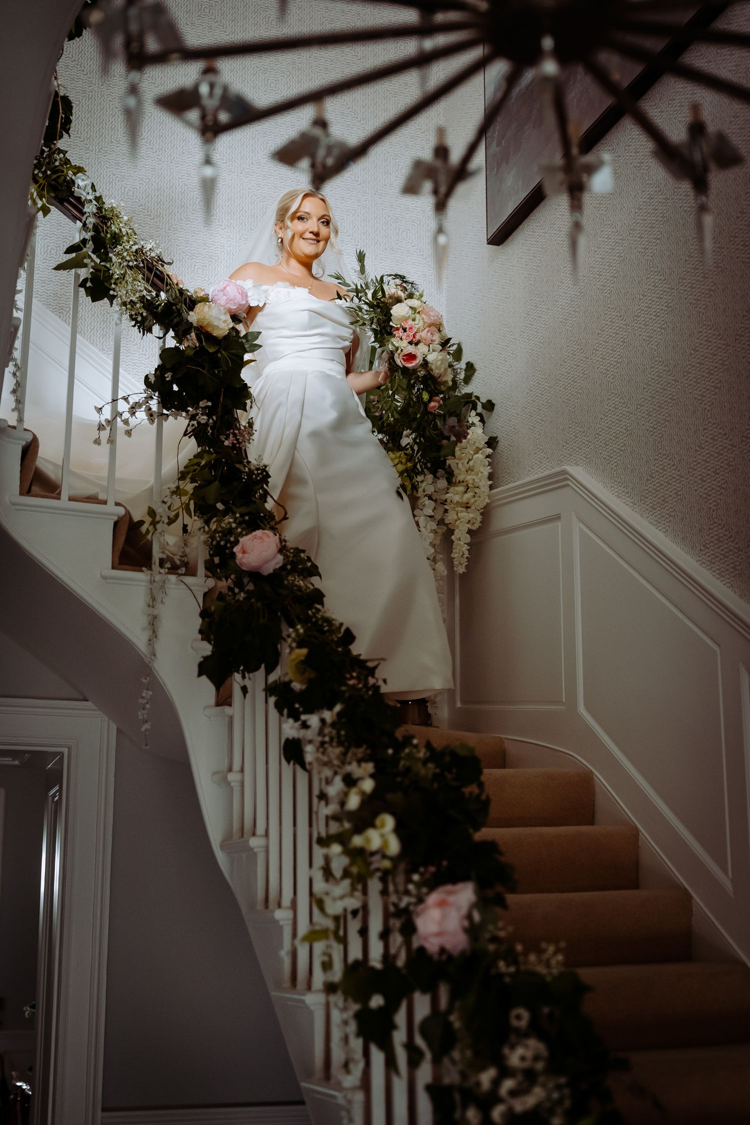 Proud father of the bride watching the first look on the stairs.