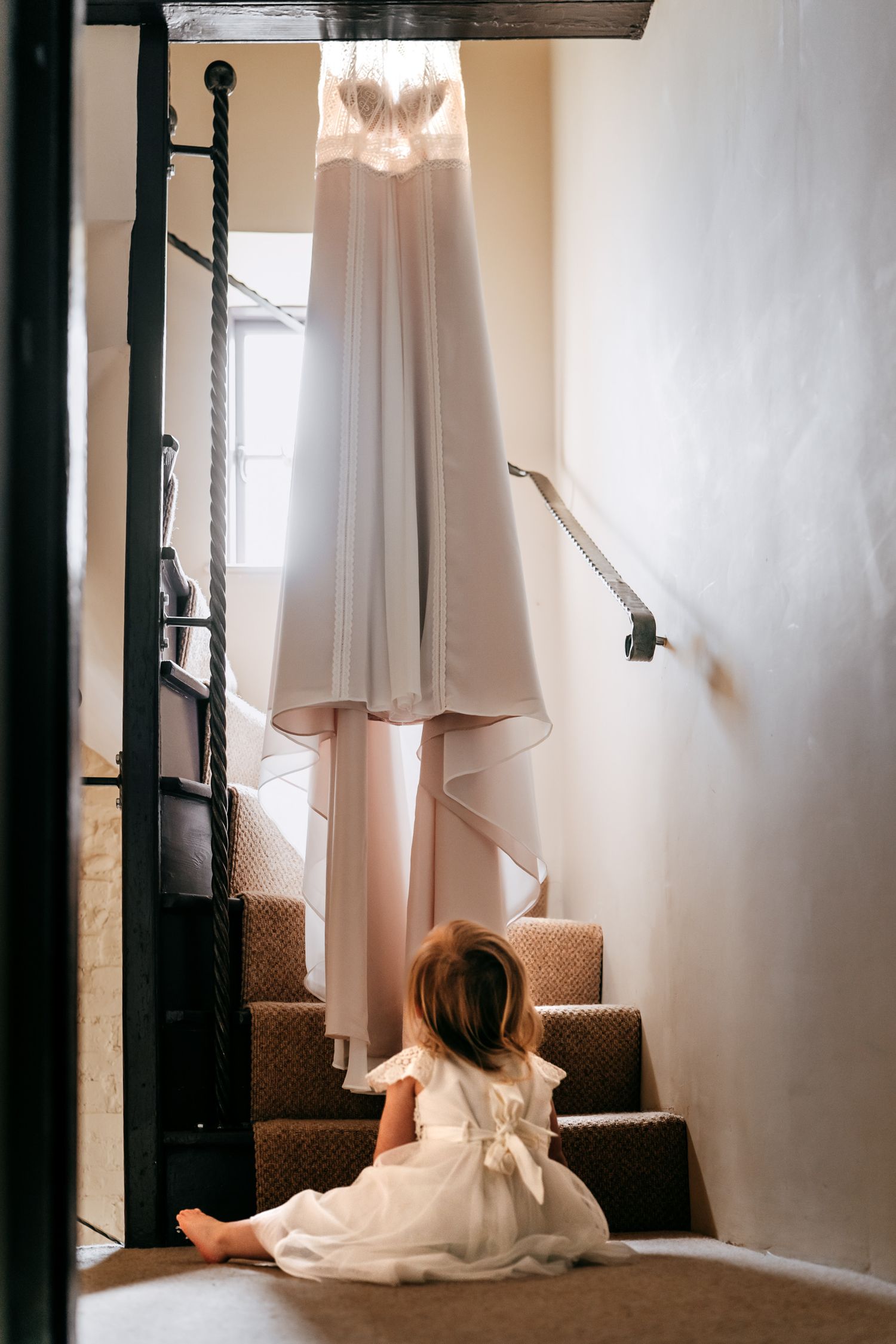 Storytelling moment of a child's first look at the bride's beautiful dress.