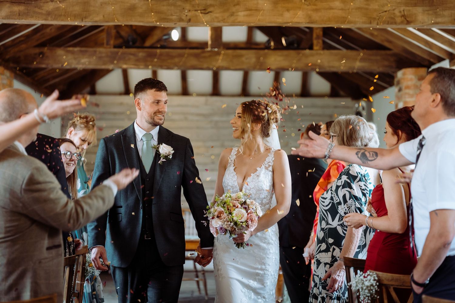 Confetti walk wedding photography in a rustic barn in Cambridgeshire.