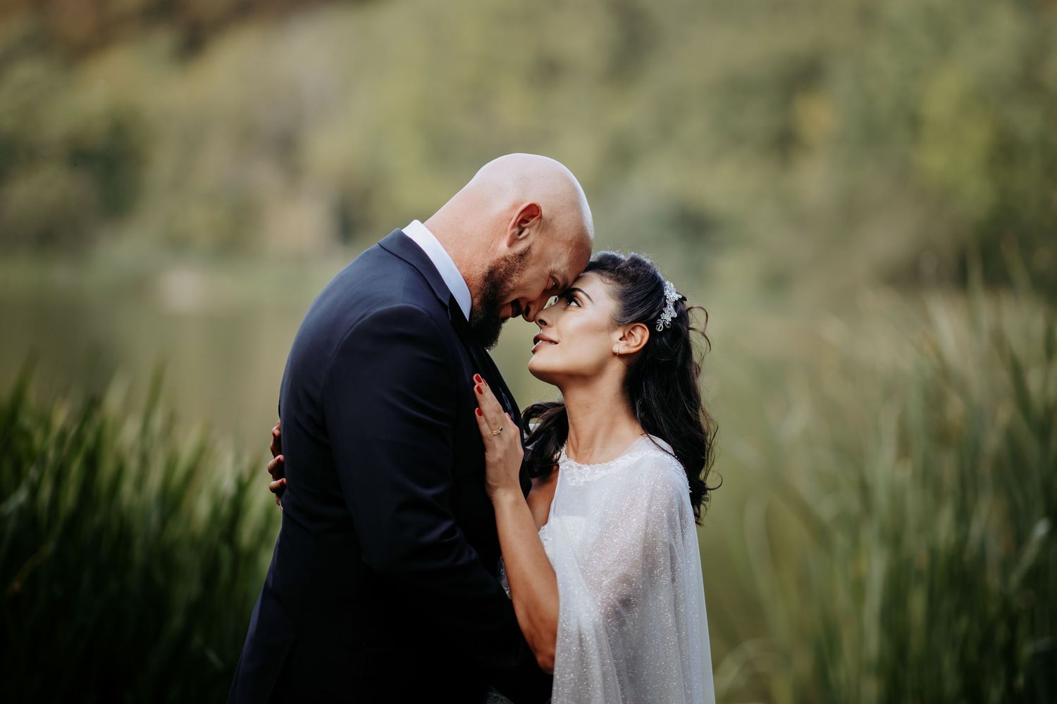 Wedding couple photography by the lake at Hinchingbrooke Park, Huntingdon.