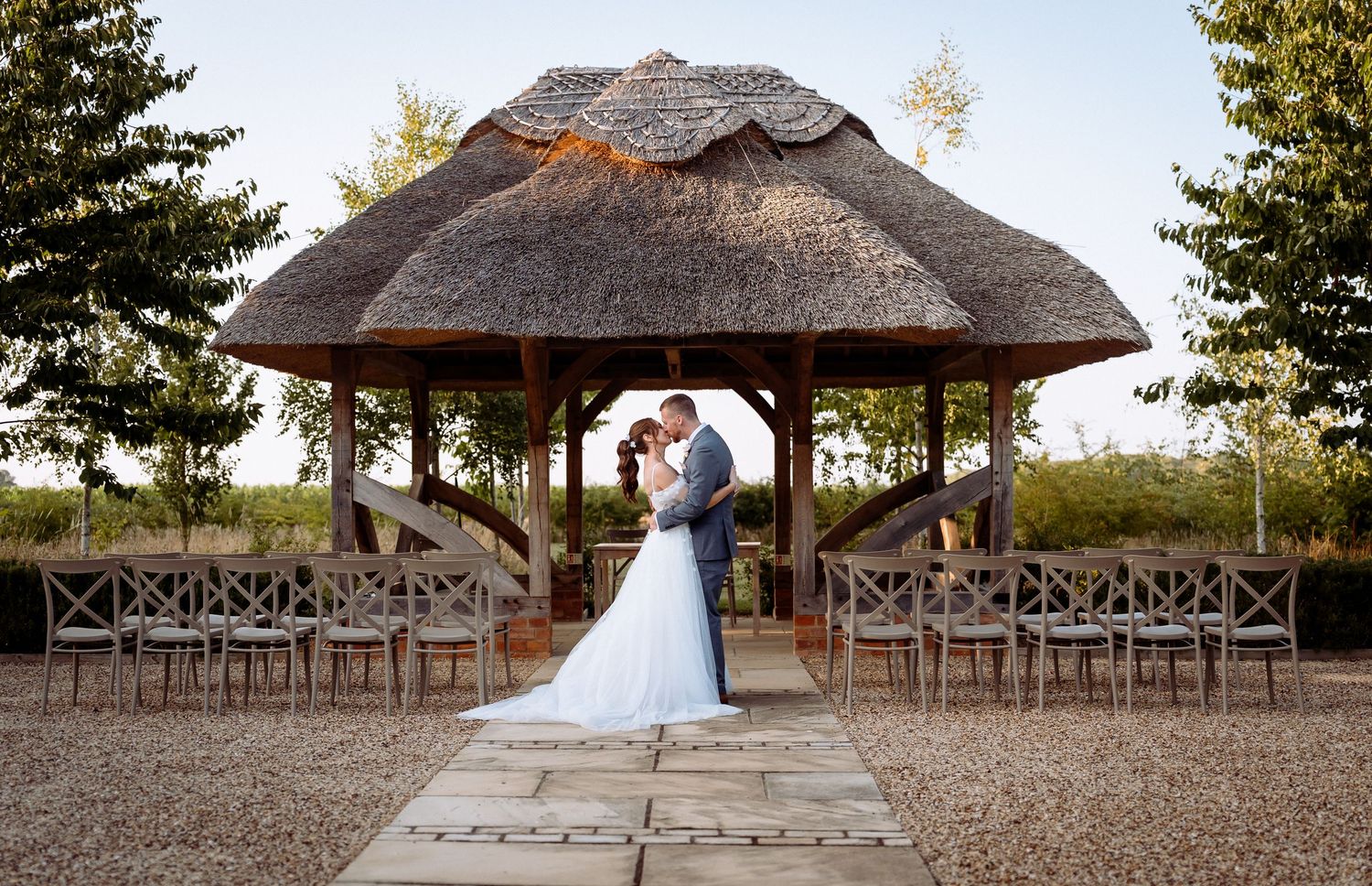 Relaxed wedding portraits in the Moat Garden at Bassmead Manor Barns, Cambridgeshire.