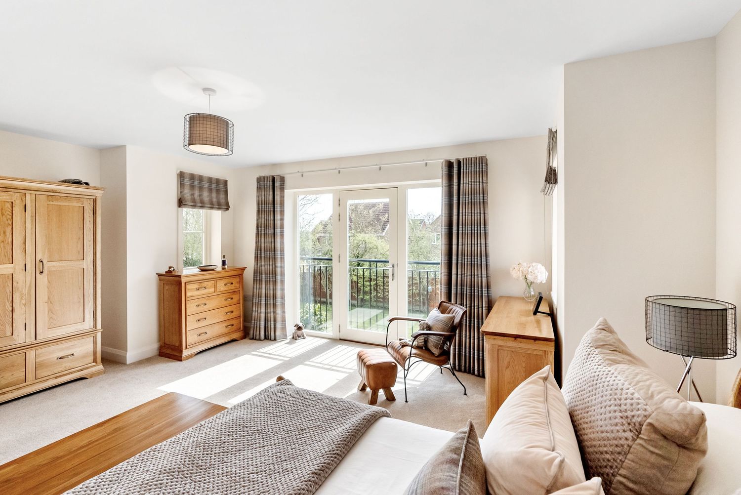 Sunny views from a classic bedroom design in a Cambridge home.