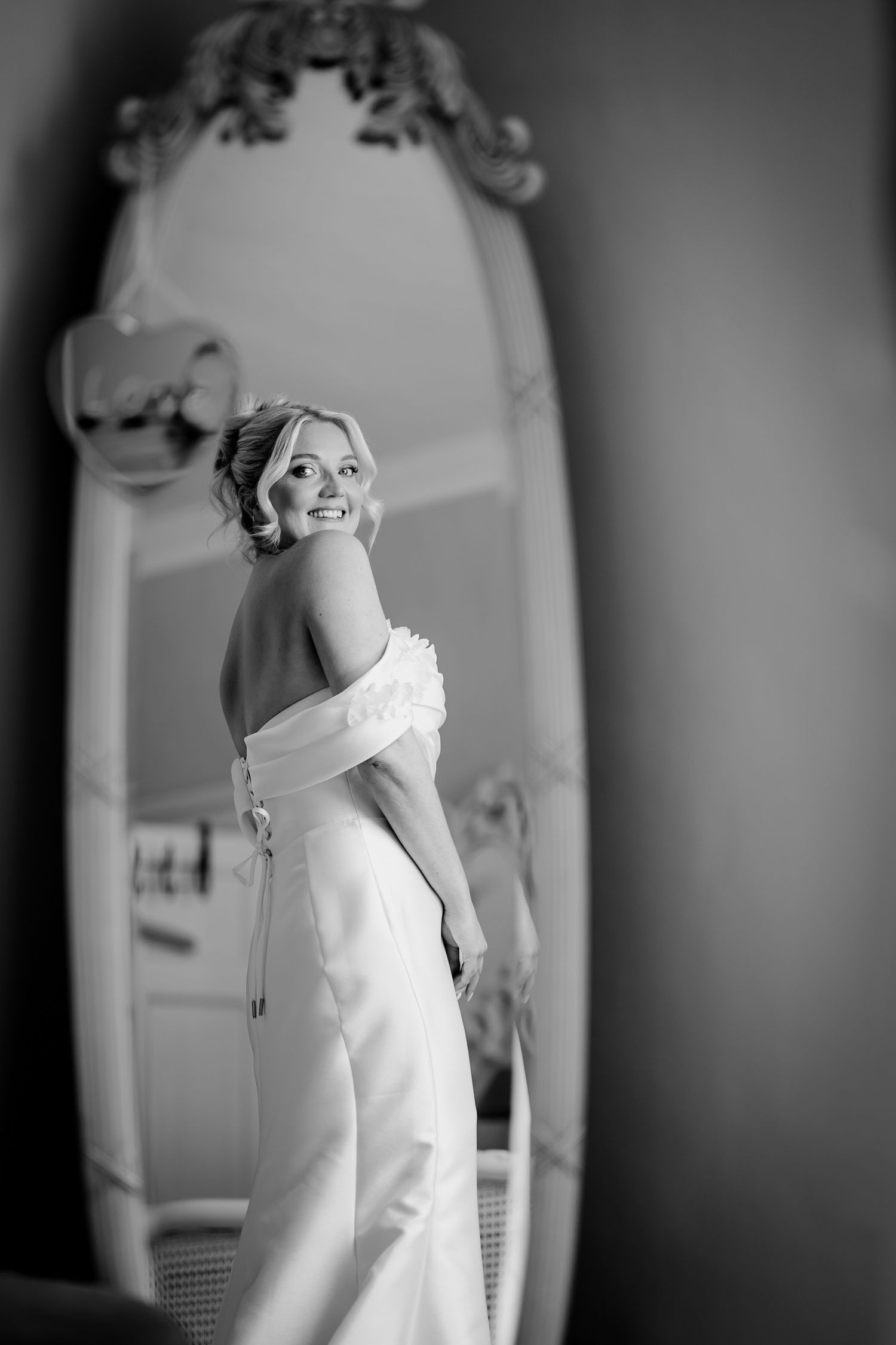 Candid wedding photo capturing a moment via a mirror reflection.