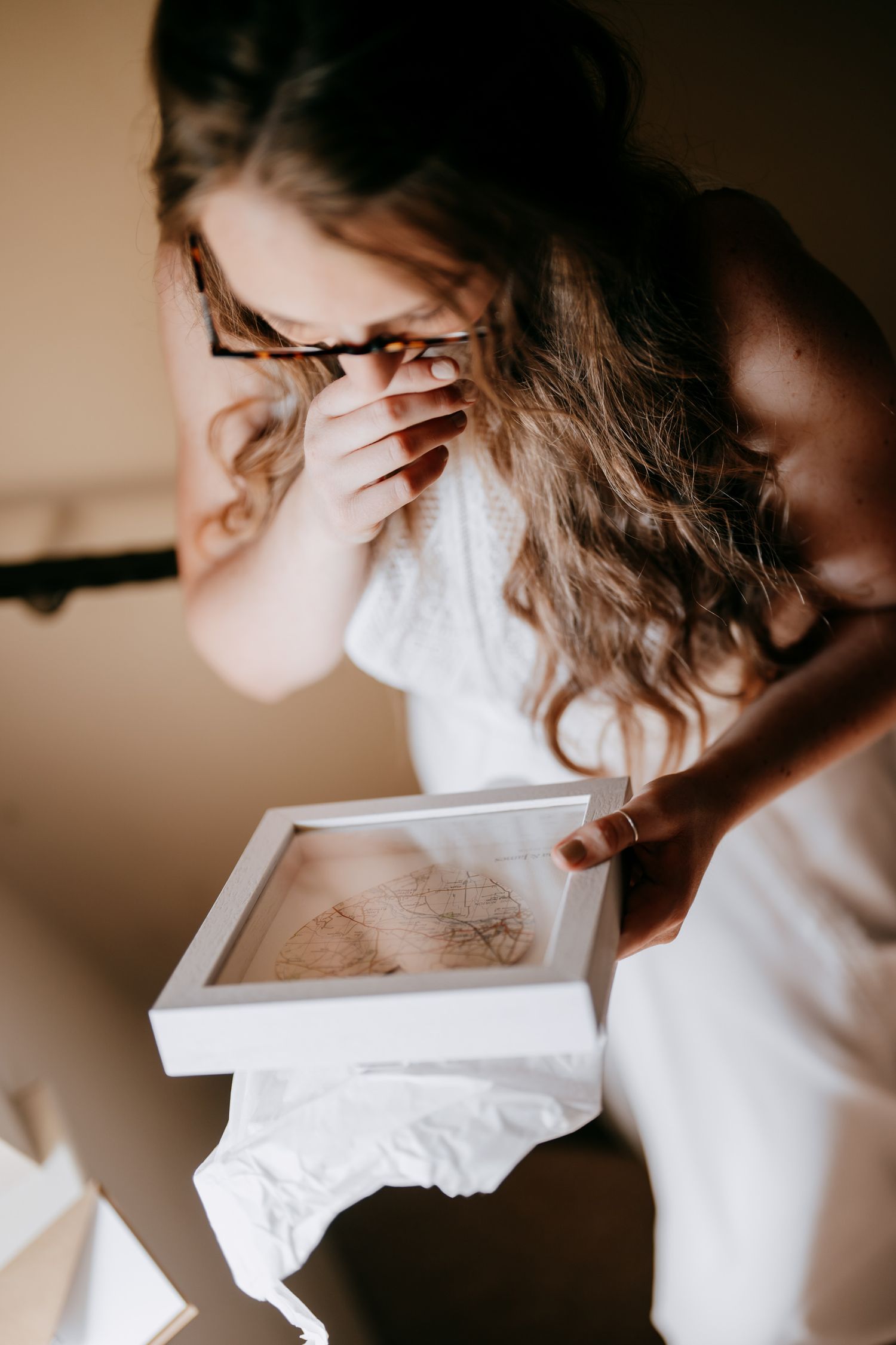 Candid wedding photography capturing an unexpected gift moment.