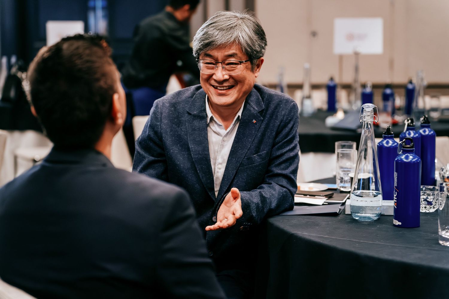 Corporate meeting photography showing delegates networking in Cambridge.