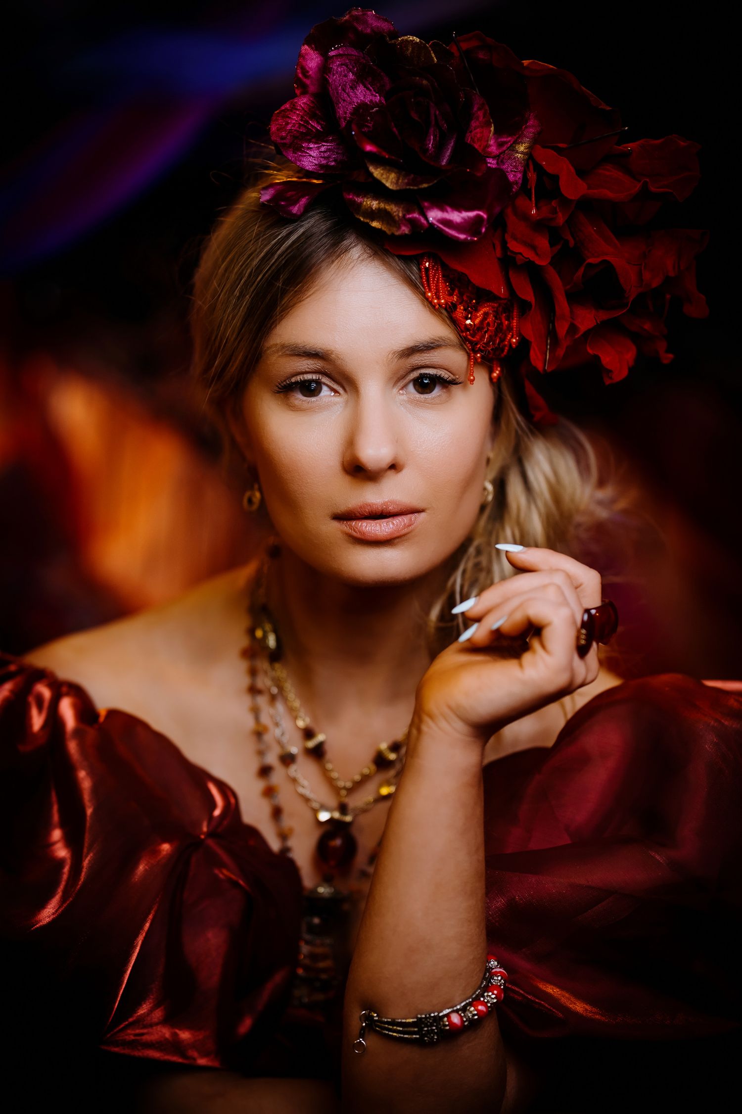 Creative portrait photographer in Cambridgeshire capturing an artistic red floral crown headshot.