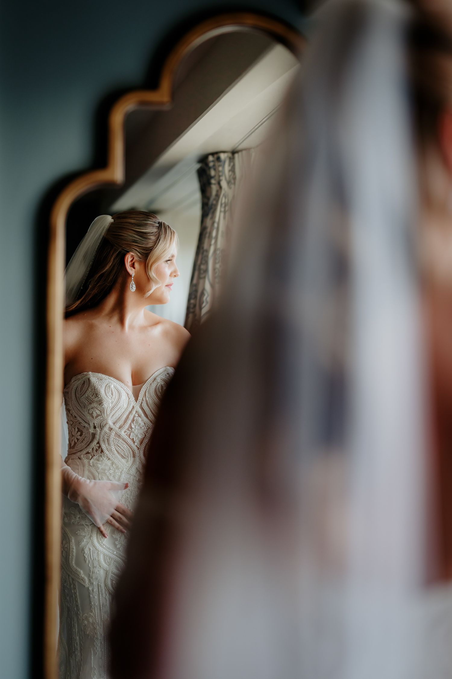 Bridal suite portrait of bride in mirror at University Arms Cambridge.
