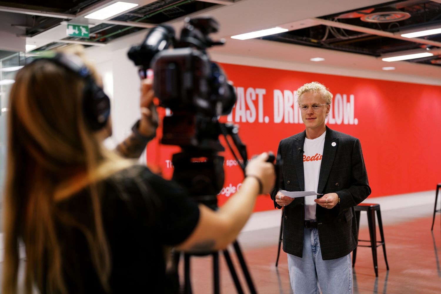Behind the scenes filming and photography at a corporate PR shoot.