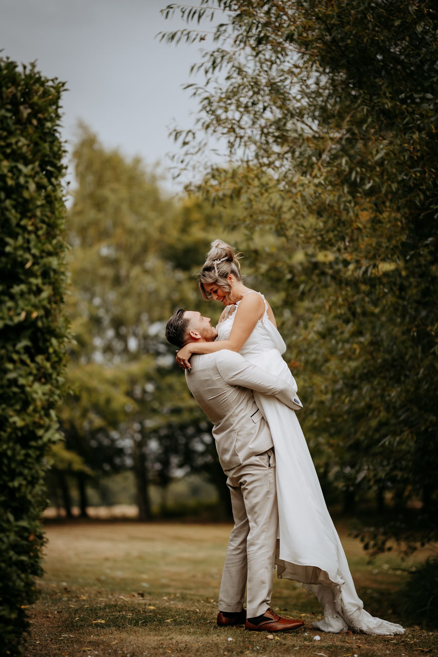 Relaxed couple lift and twirl photo at The Granary Estates wedding venue, Newmarket.