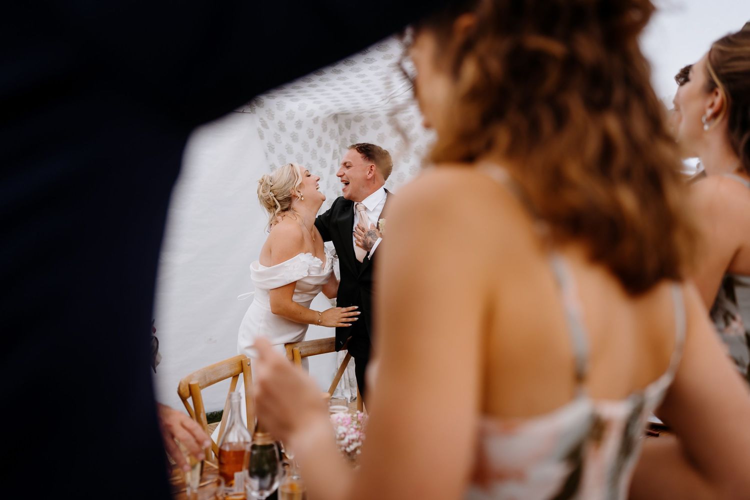 Wedding photography capturing candid moments and speeches at the party.