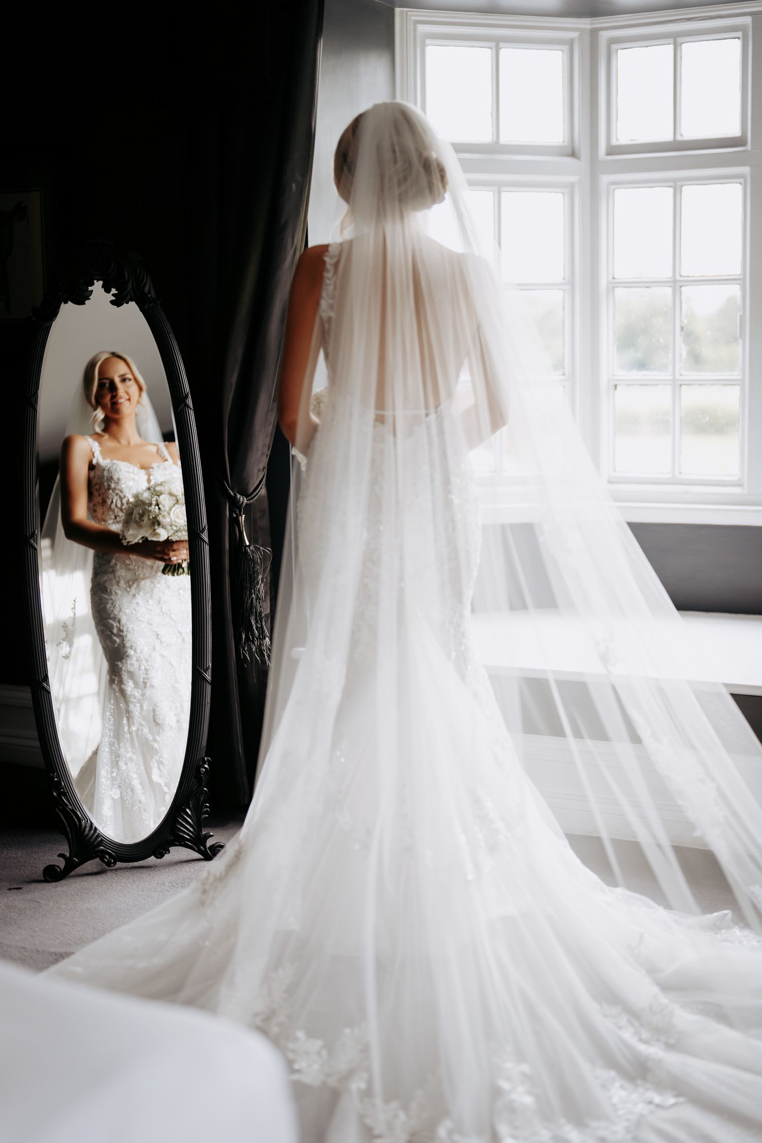 Timeless first look wedding photo at Swynford Manor with mirror reflection, Newmarket.