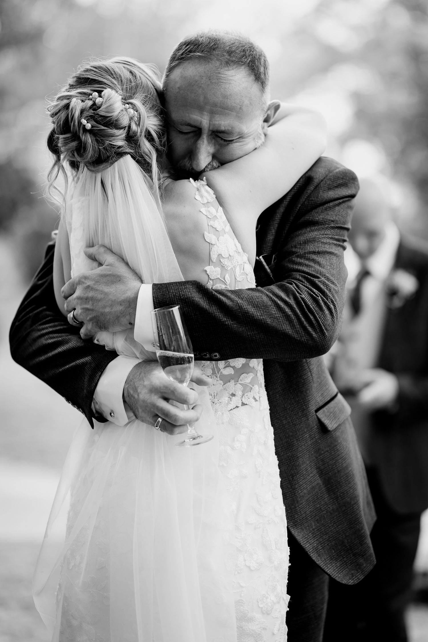 Candid wedding photo of the emotional father and bride first look.