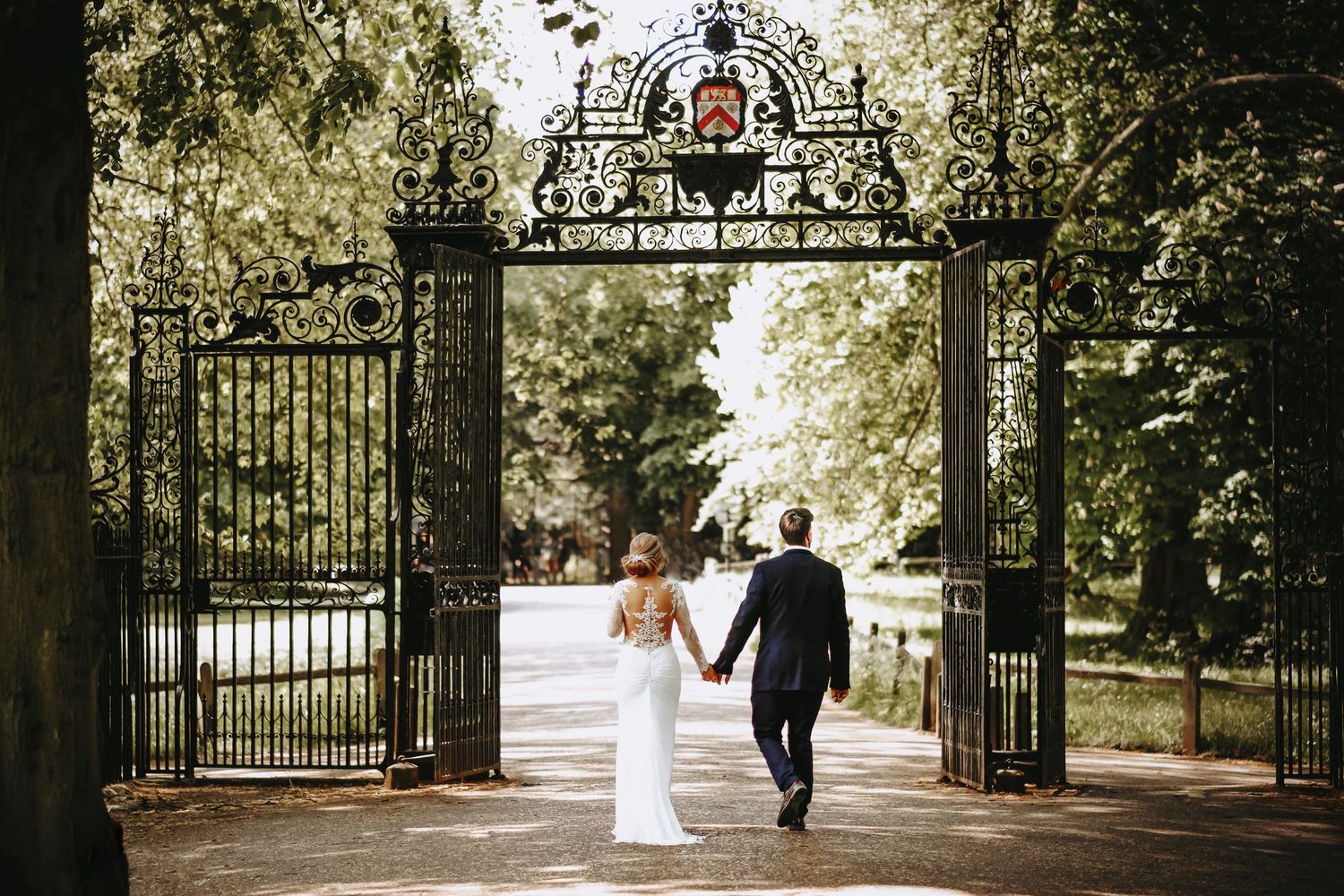 Wedding photo at the iconic gates of Trinity College Cambridge.