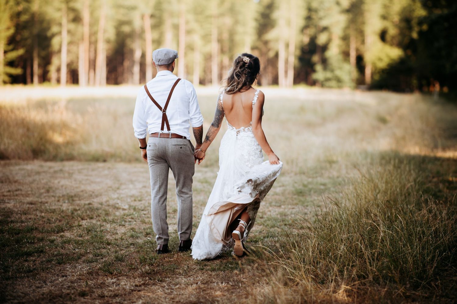 Relaxed wedding photographer in Newmarket and Cambridgeshire, capturing a couple walking in a golden field.