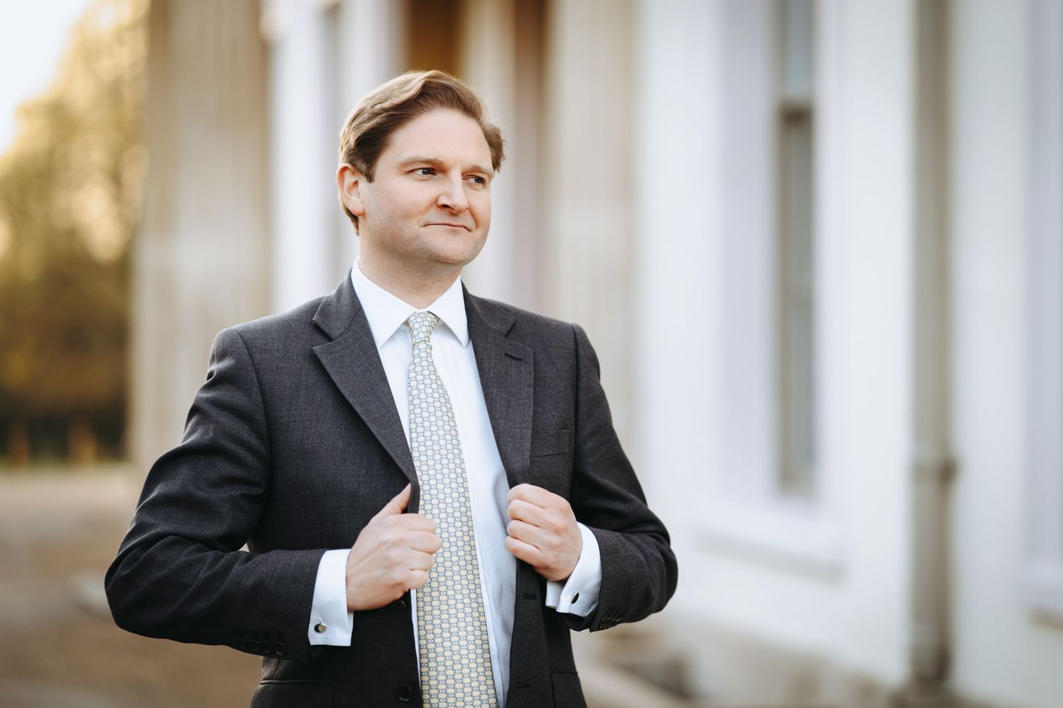 Natural light business portrait with an outdoor background in a business park.