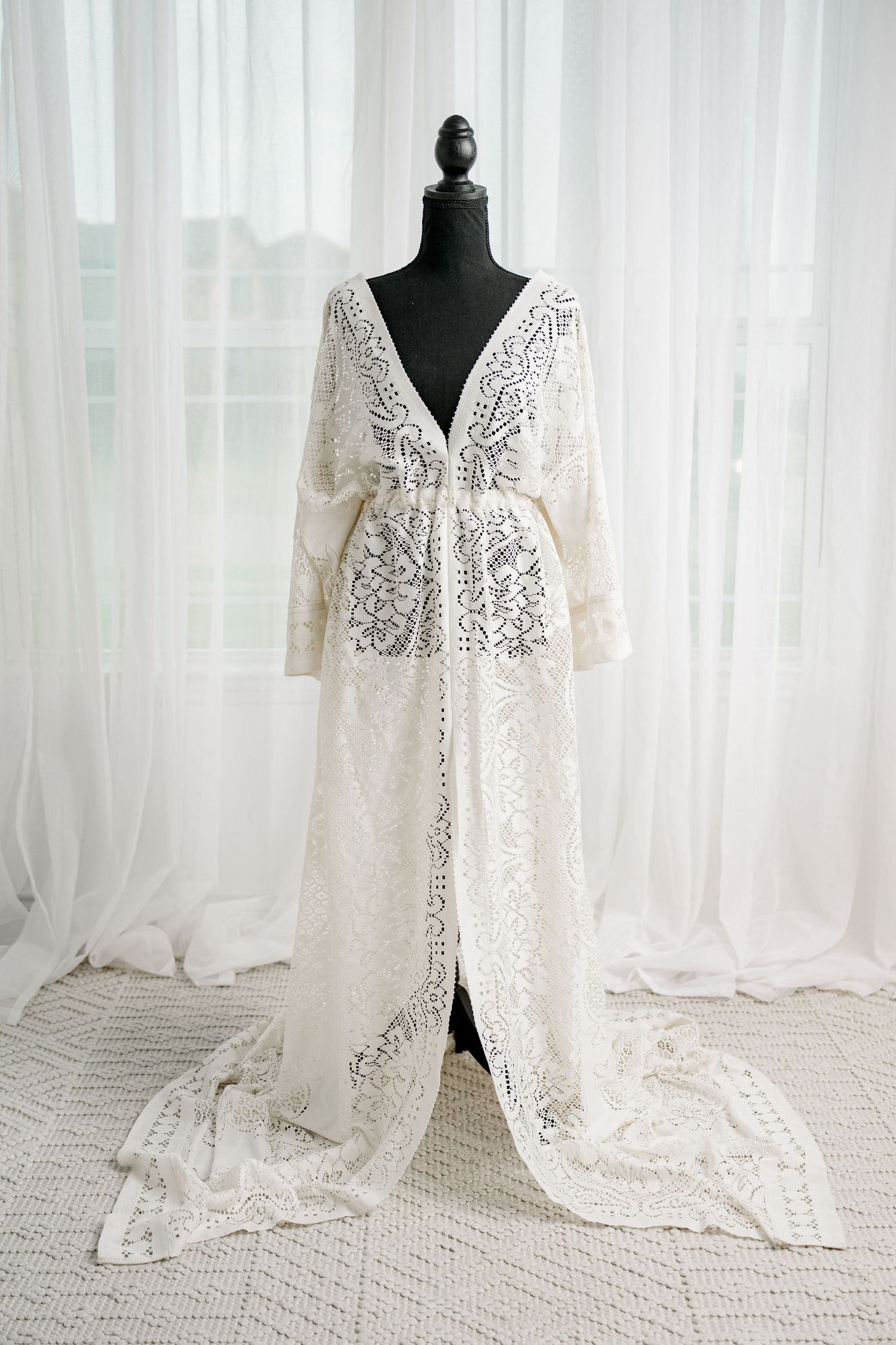 Ivory floral lace long sleeve open-front maxi robe on black mannequin.