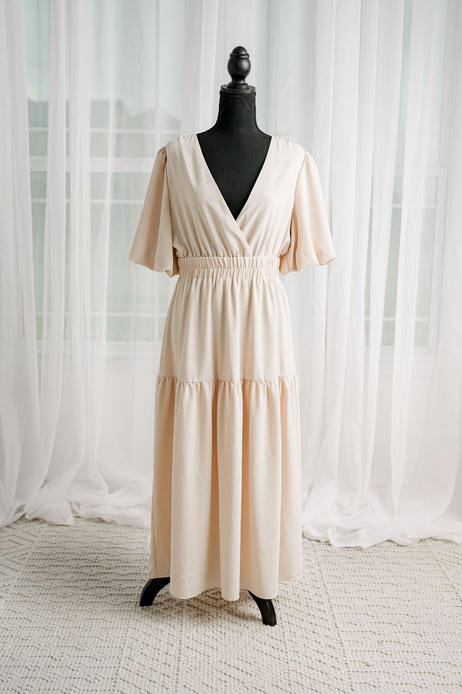 Cream V-neck flutter sleeve tiered maxi dress displayed on mannequin.