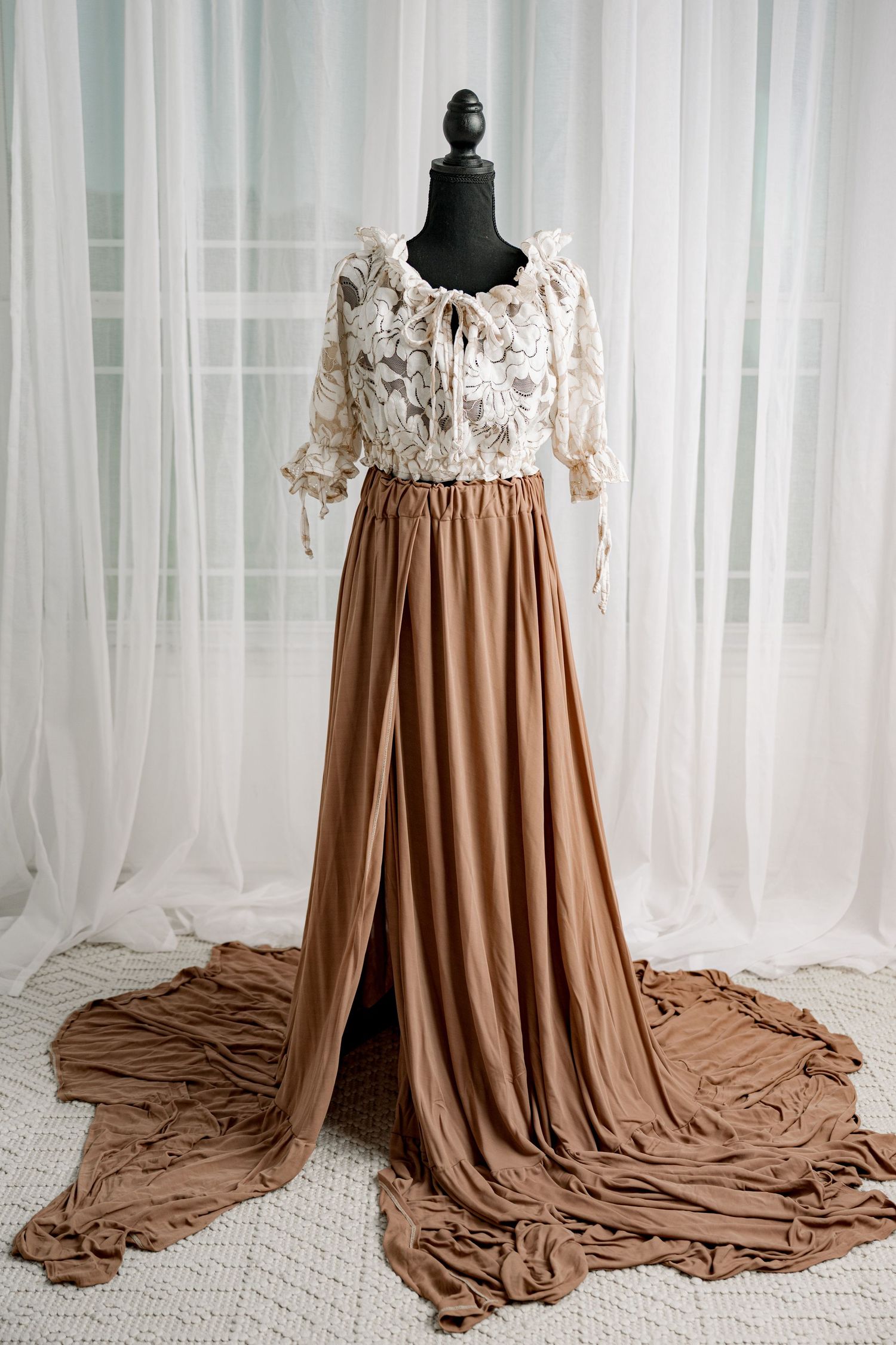 White lace bodice with caramel brown flowing maxi skirt on mannequin.