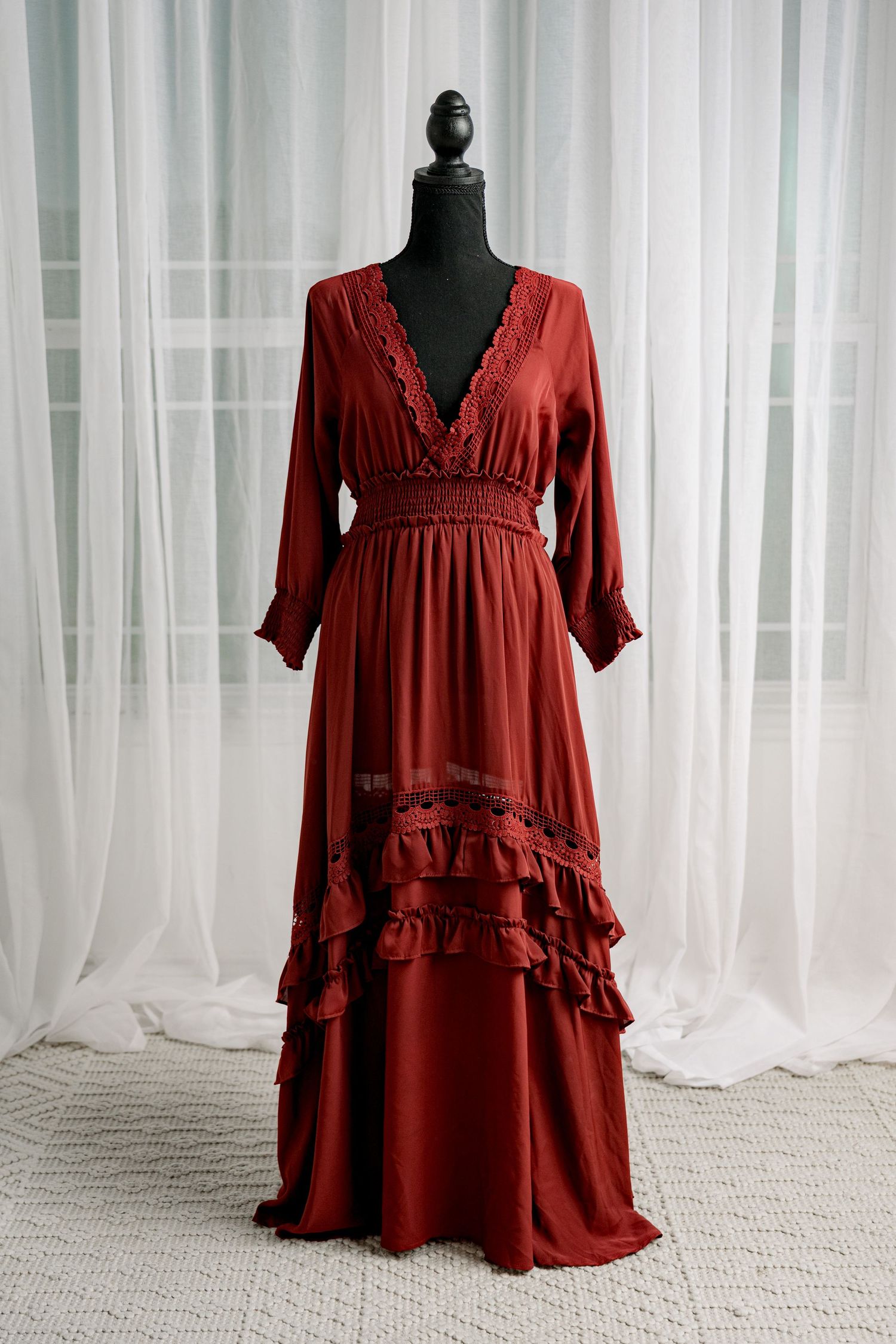 Deep red V-neck lace trim long sleeve ruffled maxi dress on mannequin.