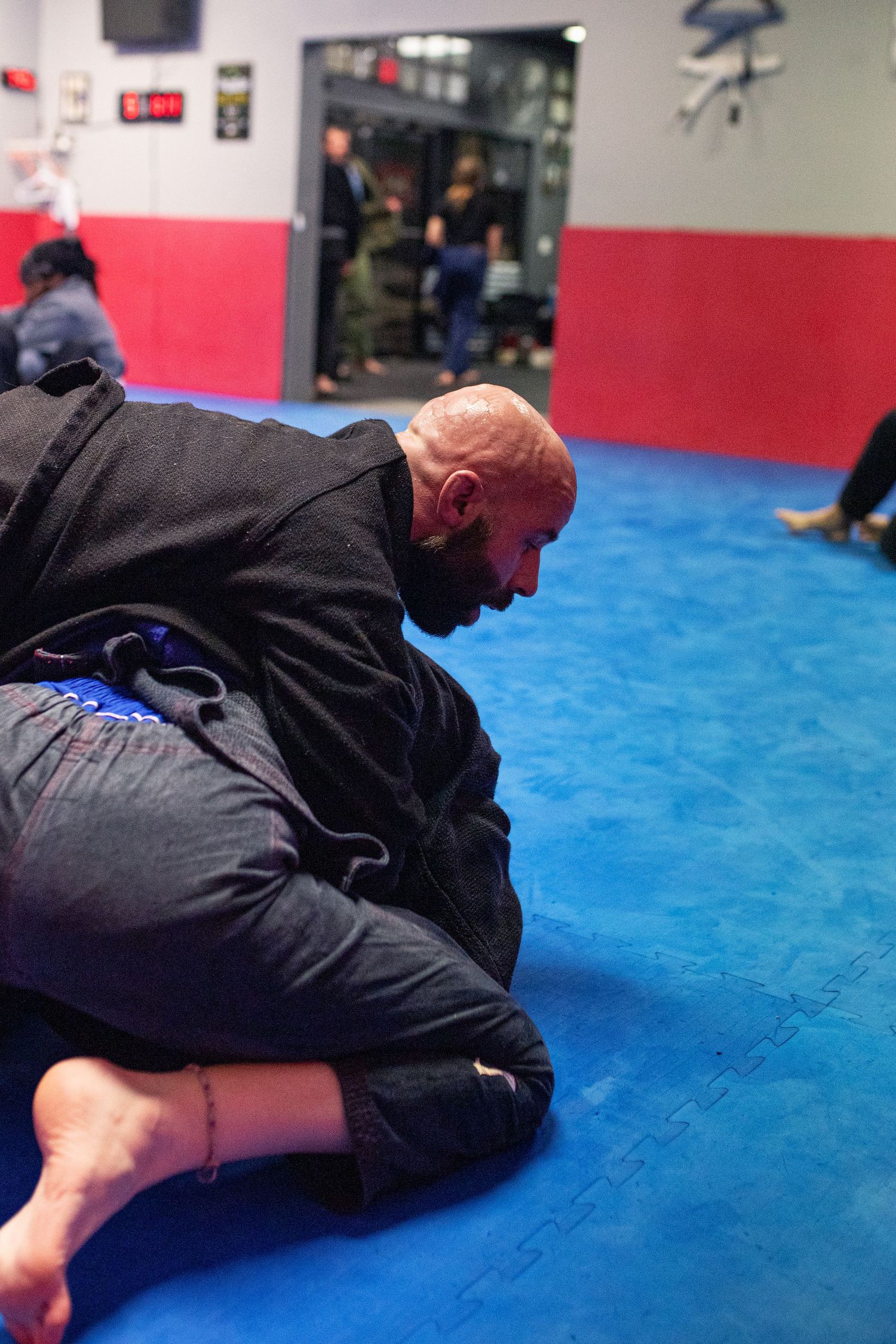 Adult Brazilian Jiu-Jitsu class training at martial arts academy in Rincon, Georgia