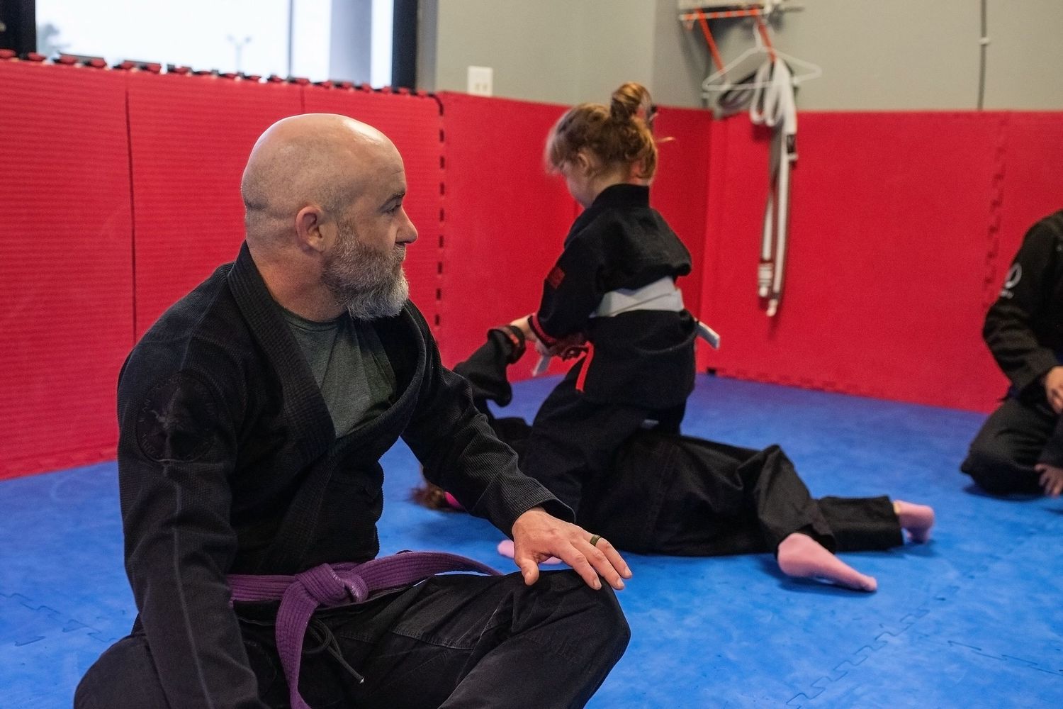 Martial arts instructor teaching kids focus and discipline