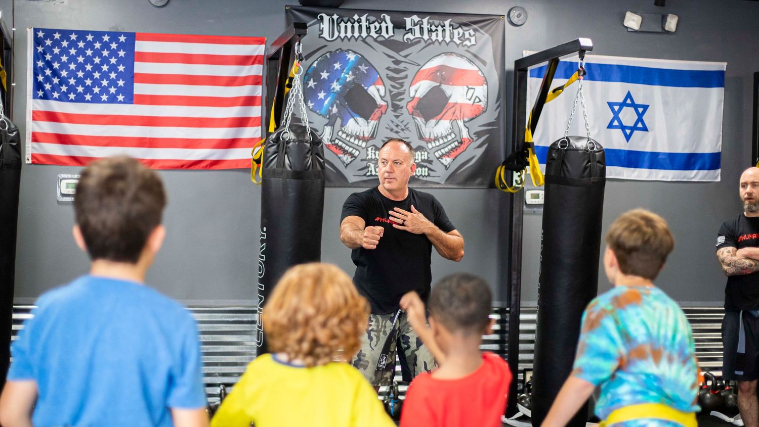 Martial arts instructor teaching kids focus and discipline