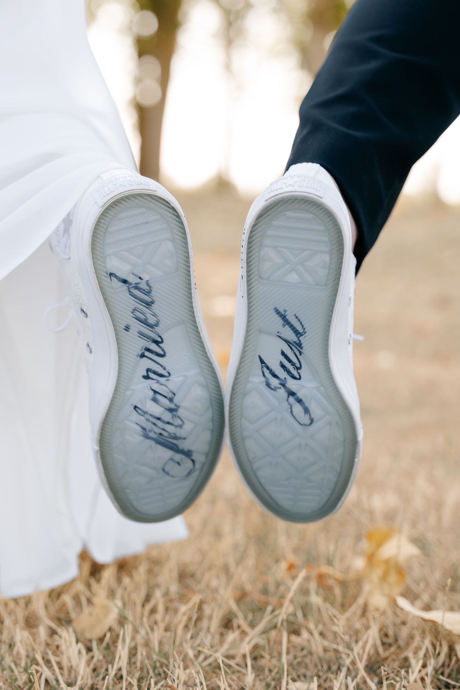 Bride and groom's white sneakers showing 
